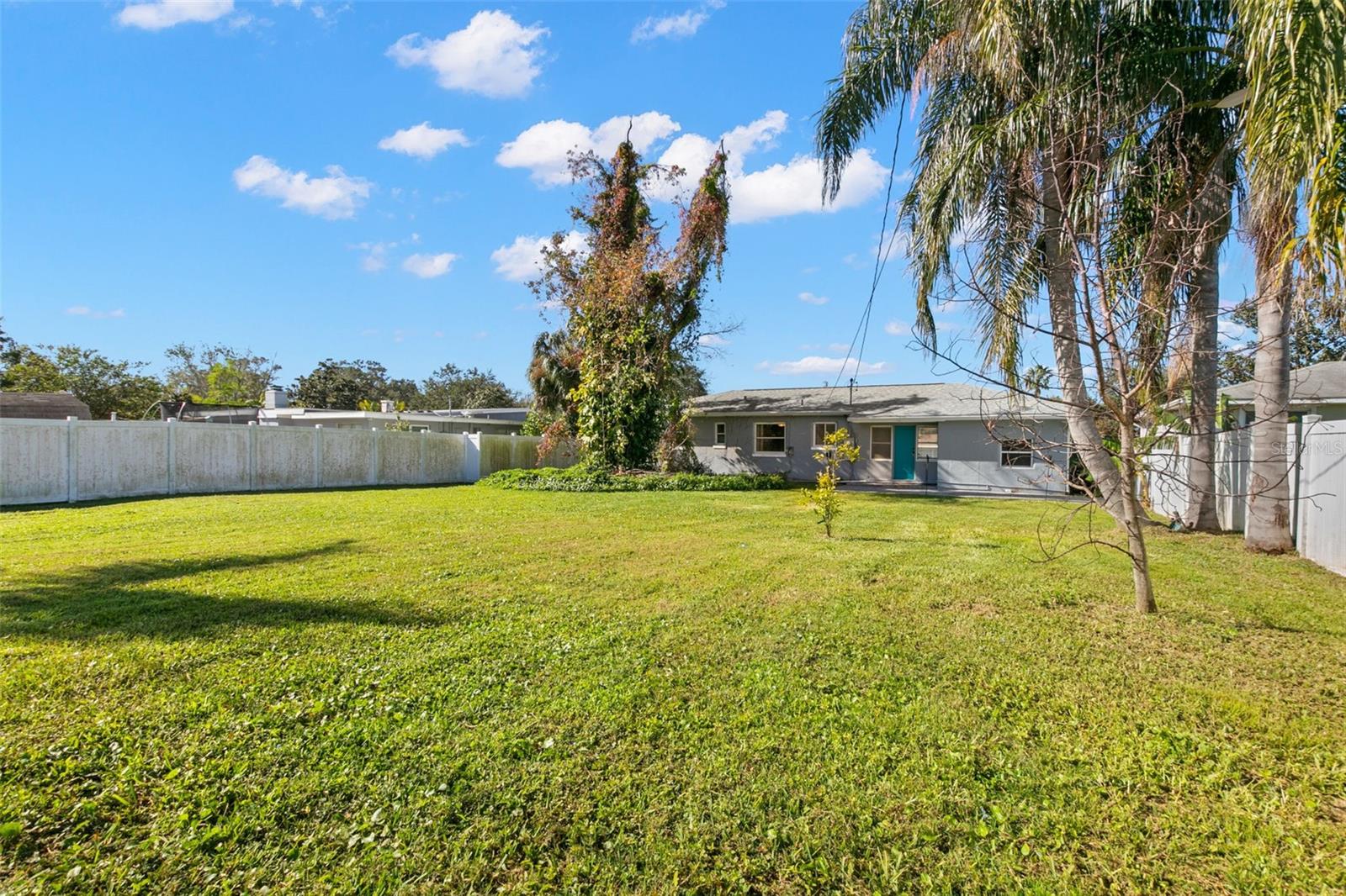 Large back yard with vinyl fencing