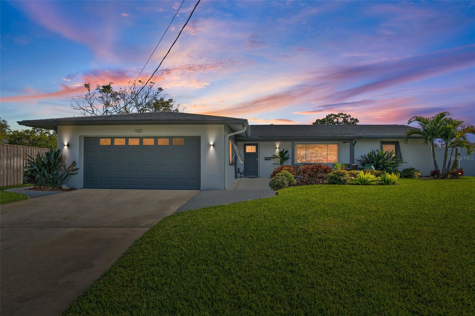 Professionally landscaped and manicured lawn exudes gorgeous curb appeal