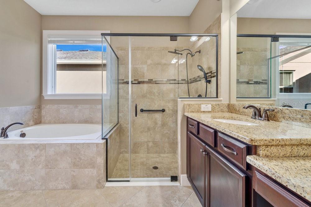 Primary bathroom with garden tub and step in shower