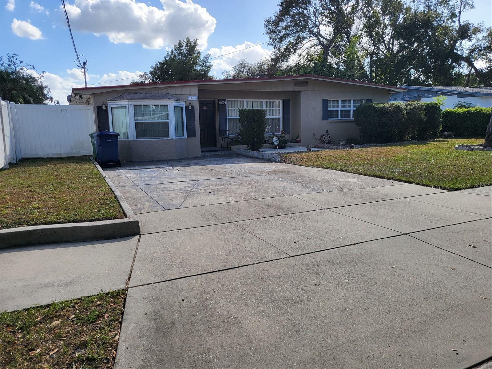 FRONT OF HOME WITH PARKING PAD