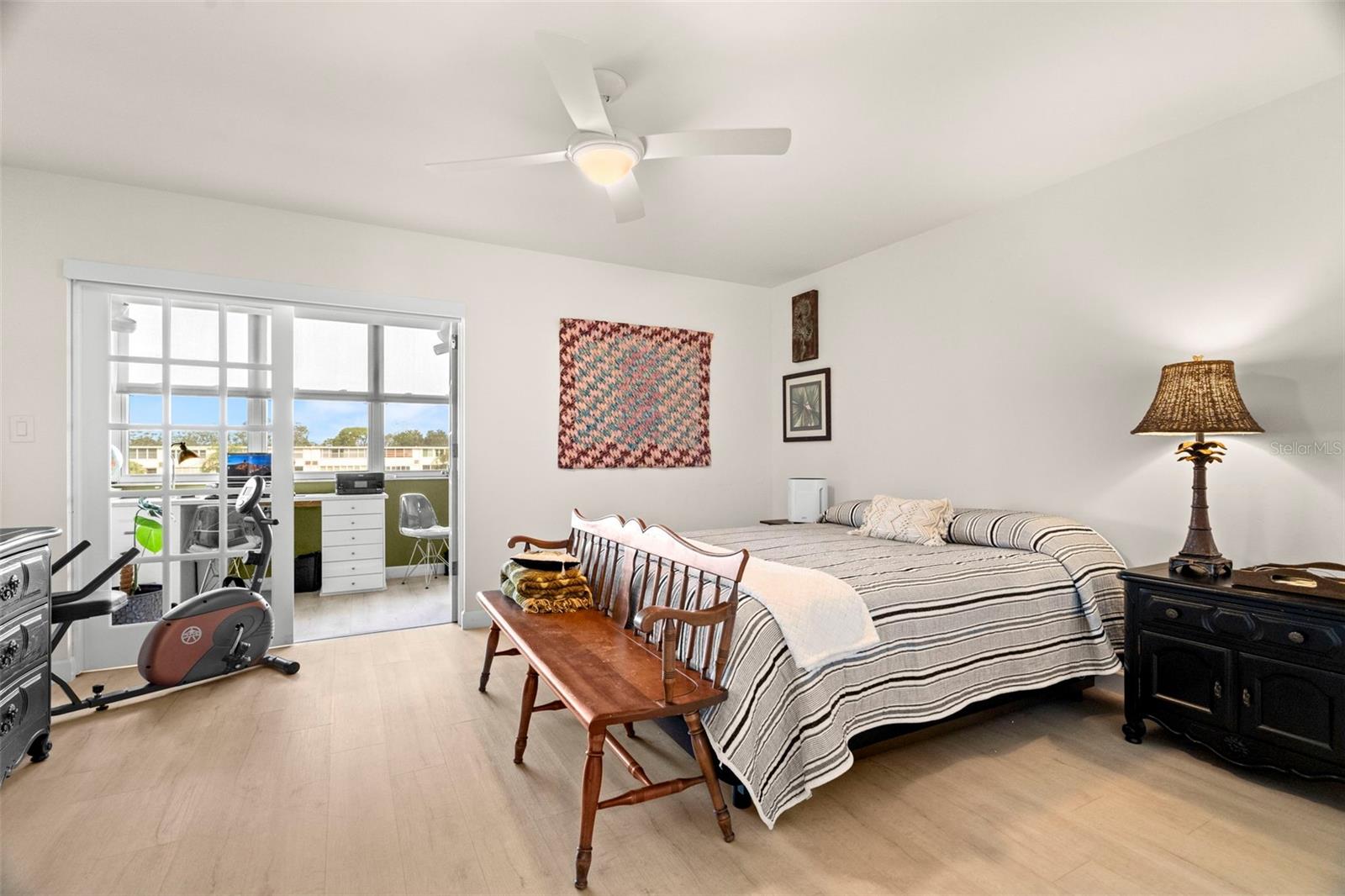 Primary bedroom with French doors to sunroom.