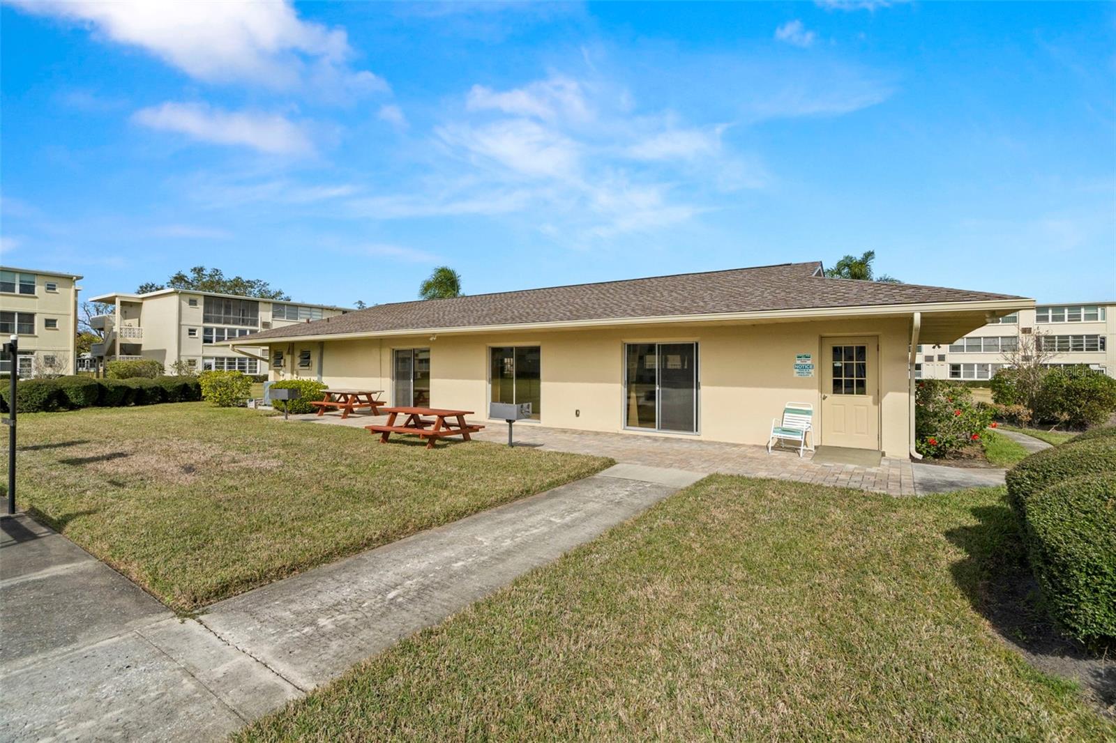 Clubhouse, grilling area and picnic tables.