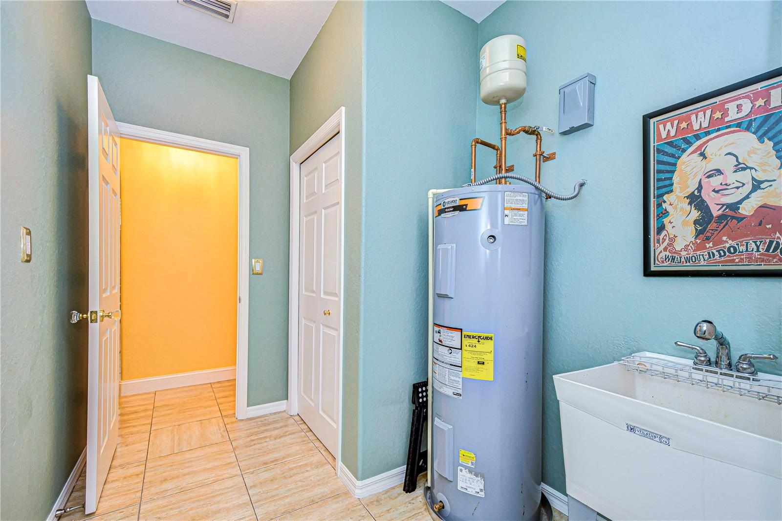 Water heater and sink heading towards garage