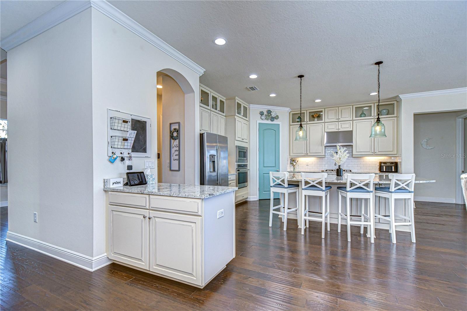 Beautiful kitchen boasting granite countertops, stainless steel appliances, and under cabinet lighting.