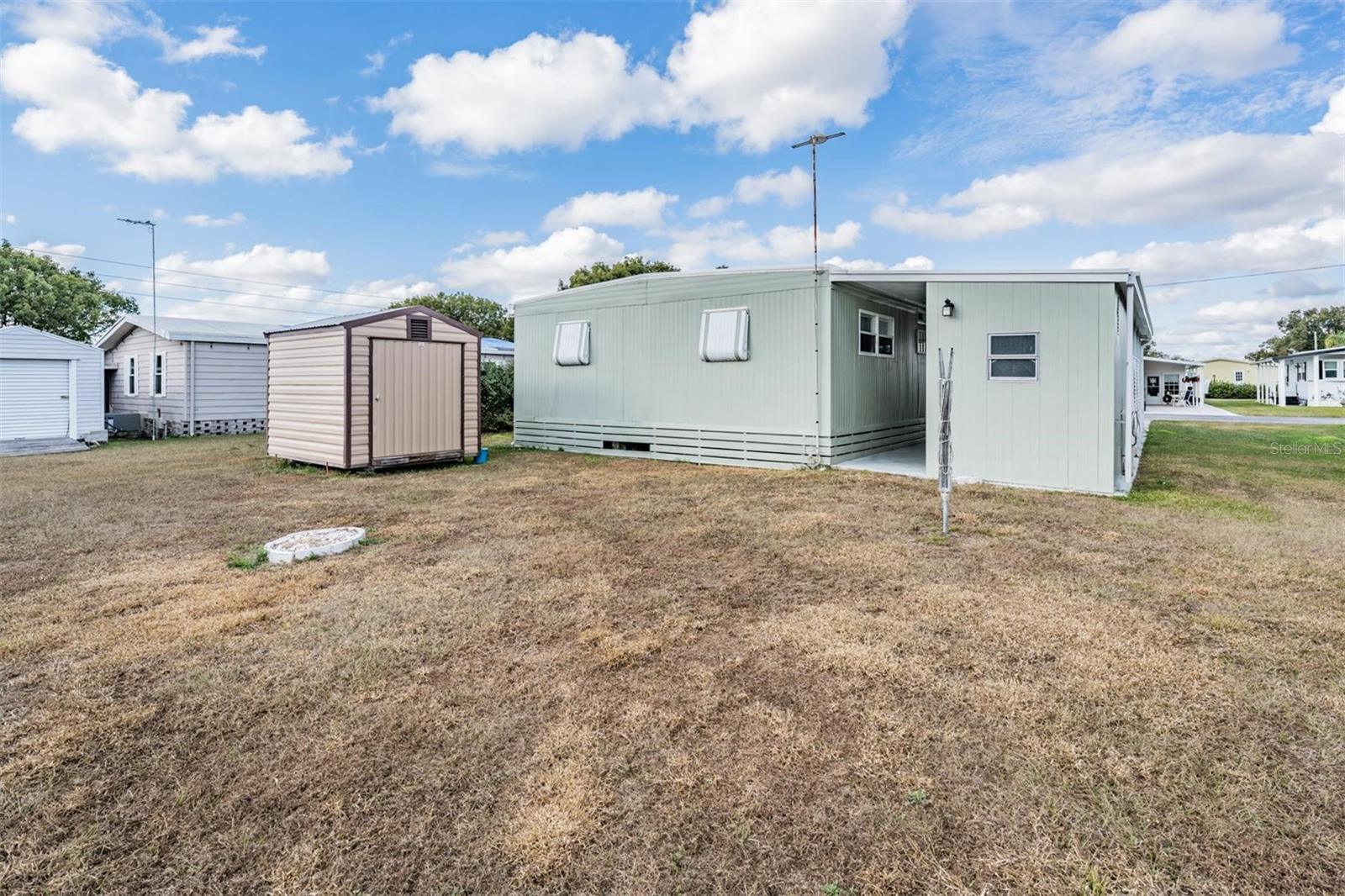 Large backyard with detached shed for golf cart