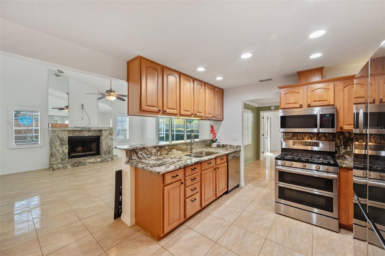 Kitchen looking at family room. Wood burning fireplace. Family room ceilings are vaulted.