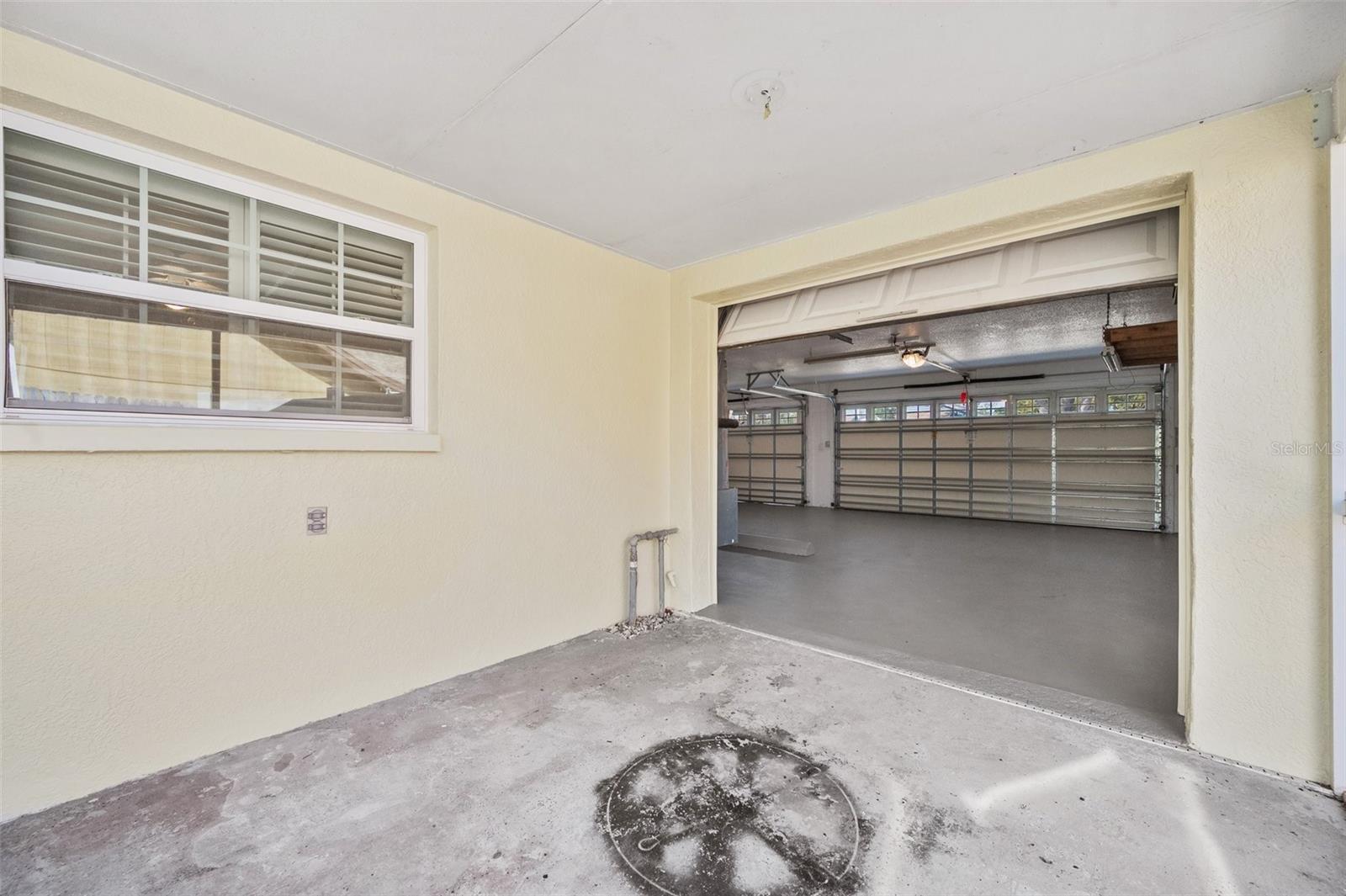 Garage entry 3rd stall to patio / lanai. New pics coming soon. Freshly painted grey floor.