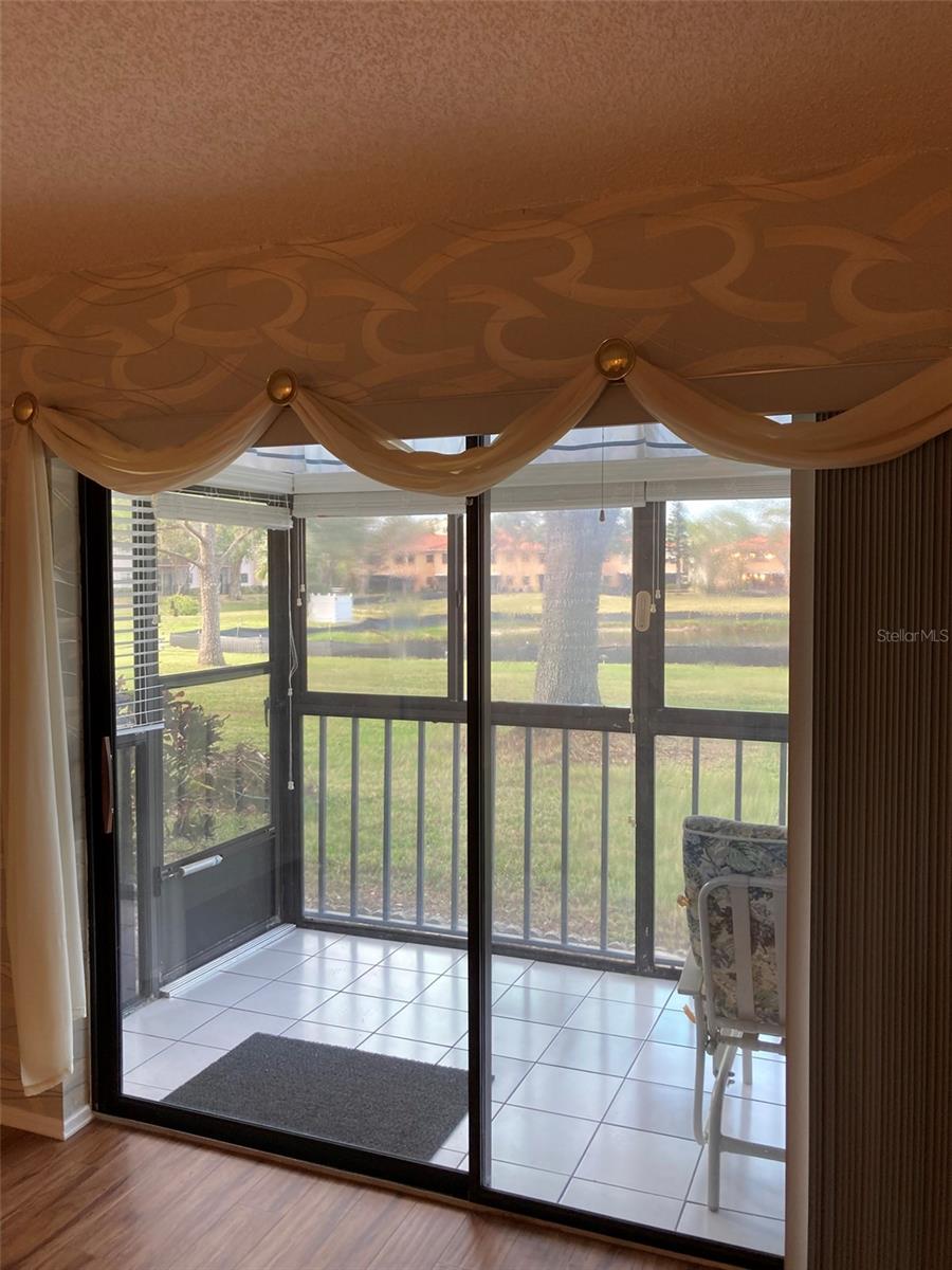 Screened enclosed patio facing the pond