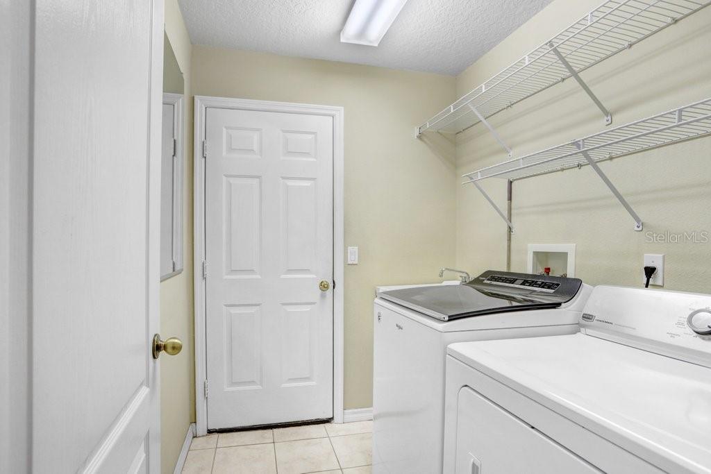 Laundry room with new washer and dryer that convey