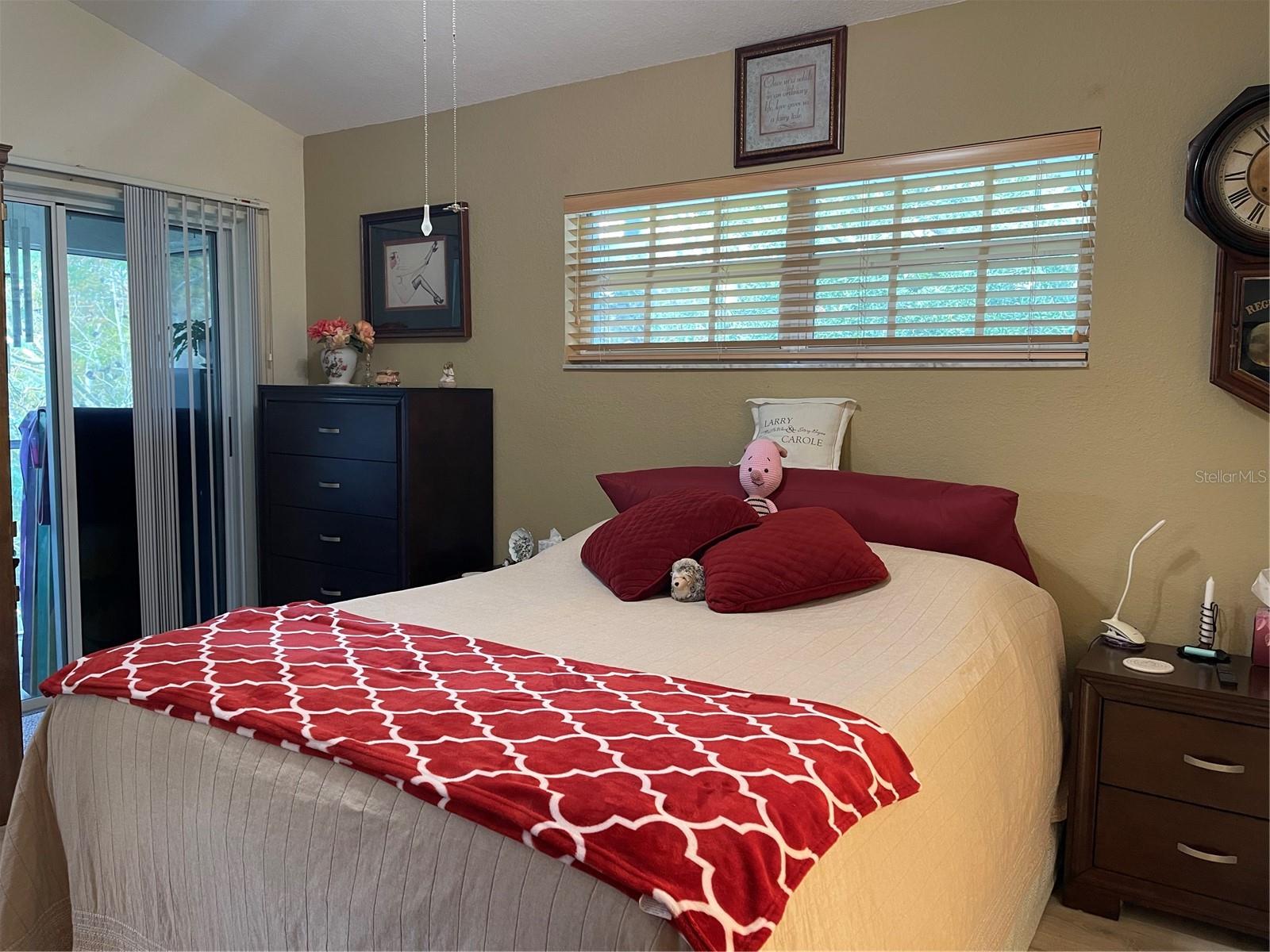 Primary bedroom has private screened balcony that overlooks the woods.