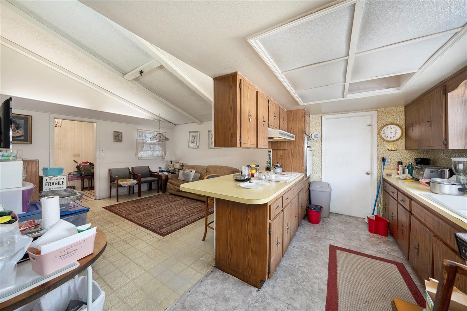 Remove ceiling cabinets for an open sightline to the second living room.