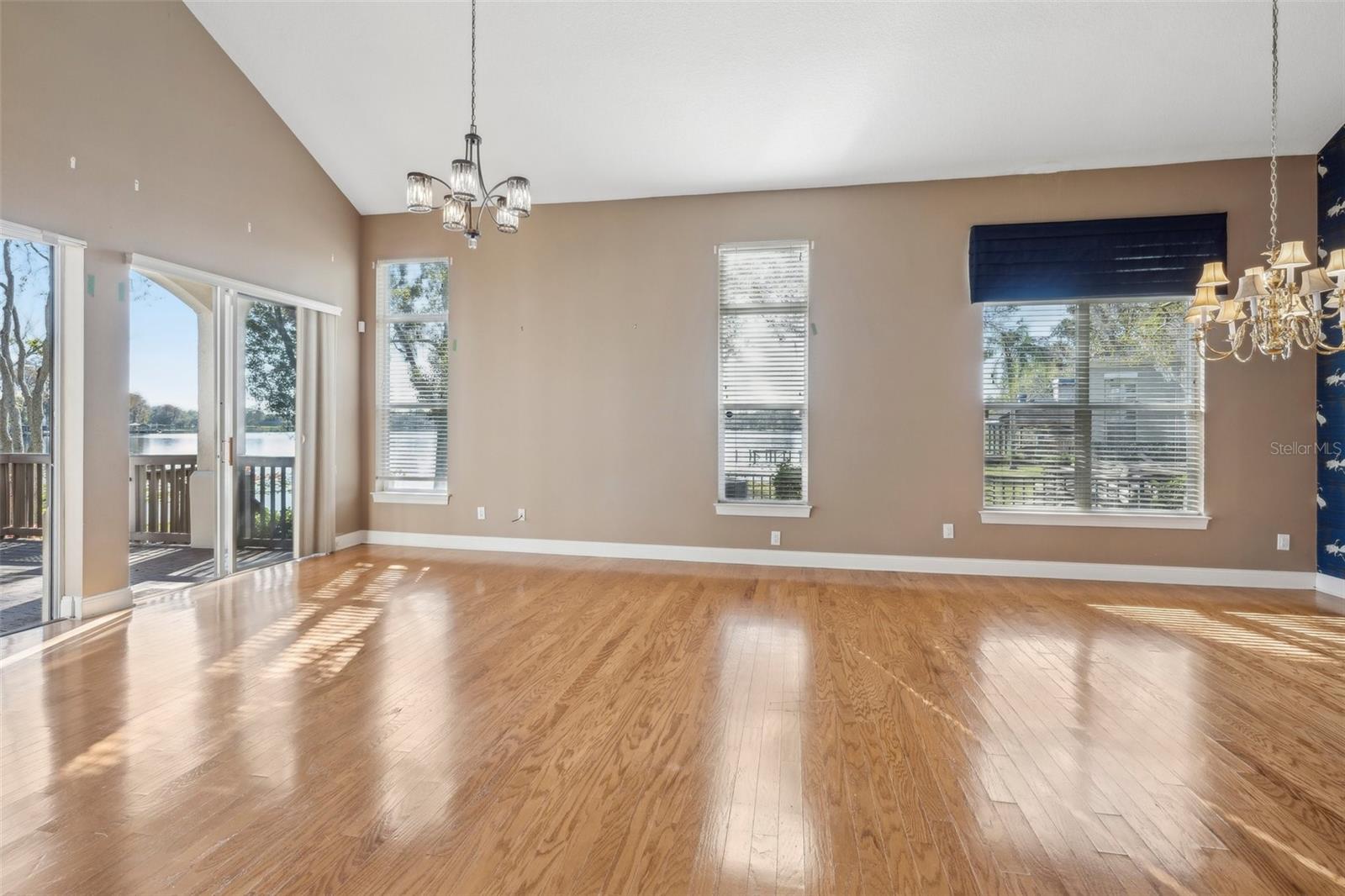 Great room with views of lake and glass sliders to deck