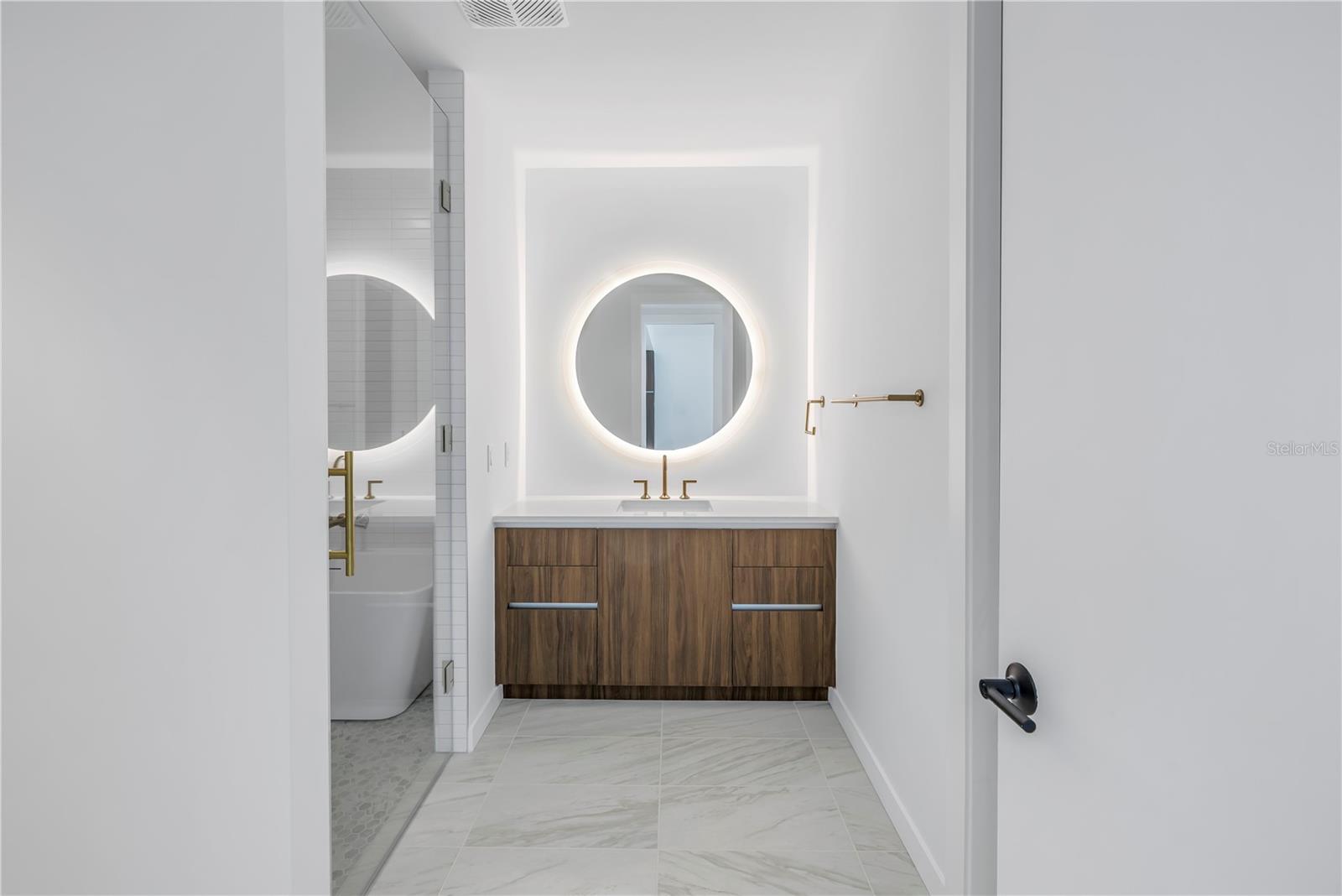 Primary bathroom with backlit mirror