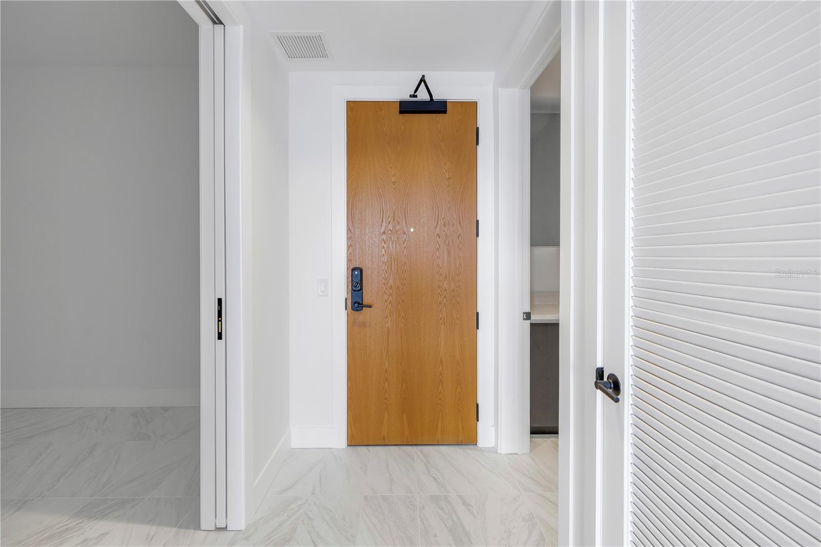 Looking back towards entry with large den on the left and huge laundry room to the right