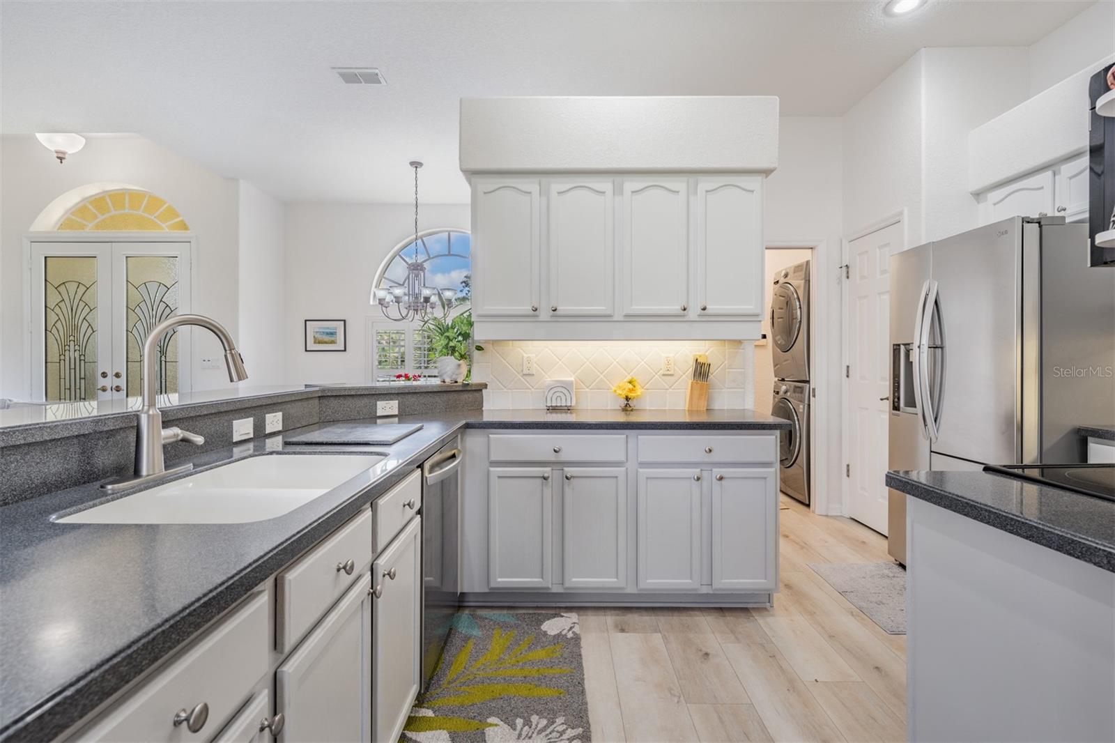 Wood cabinets are custom painted for a light bright look