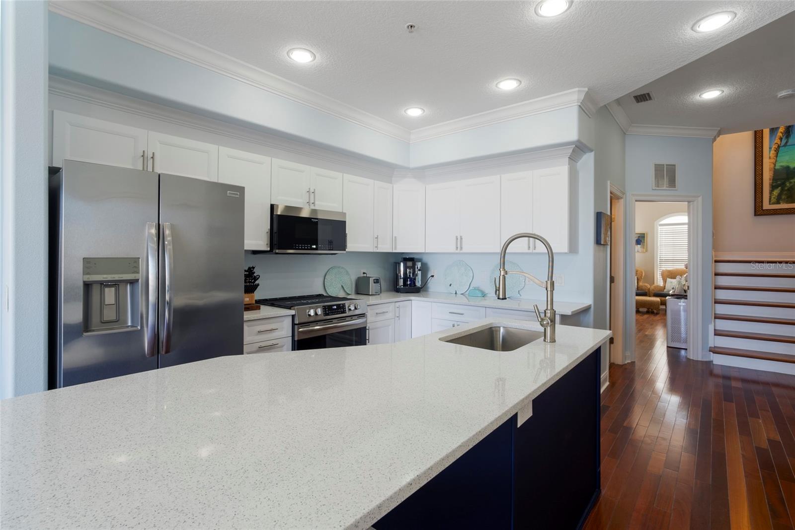 Kitchen leads towards the front of the building with full bath and spacious guest bedroom.  You can take the stairway or the elevator up to the third floor or your private rooftop terrace.