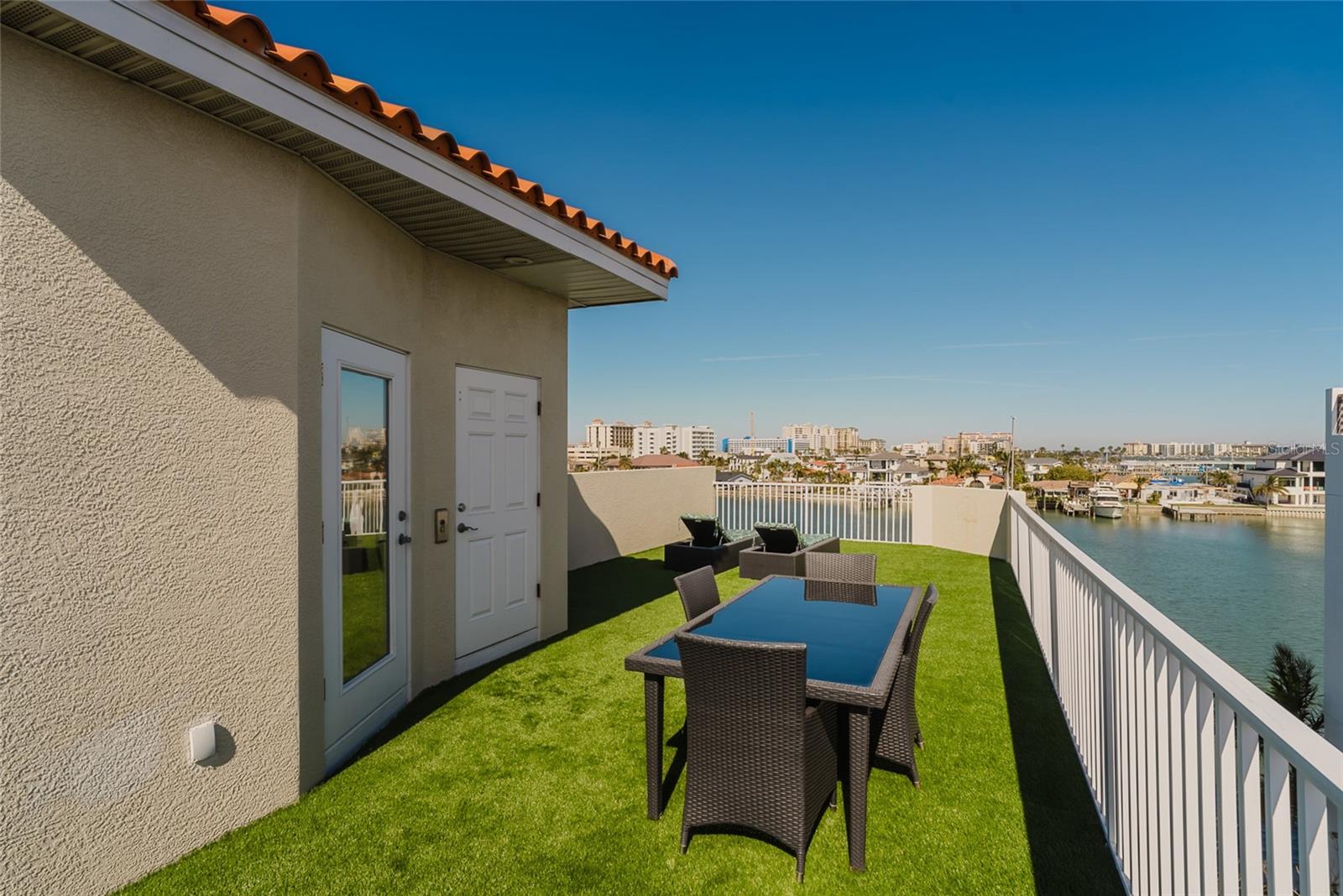 Rooftop terrace with artificial turf installed 2022.  First doorway is from Spiral Stairway and the second is the elevator!