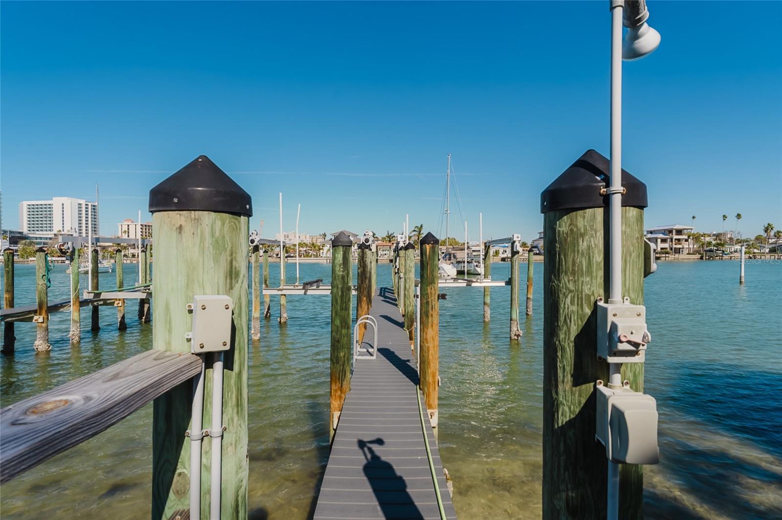 Dock leading out to boat slip with lift.