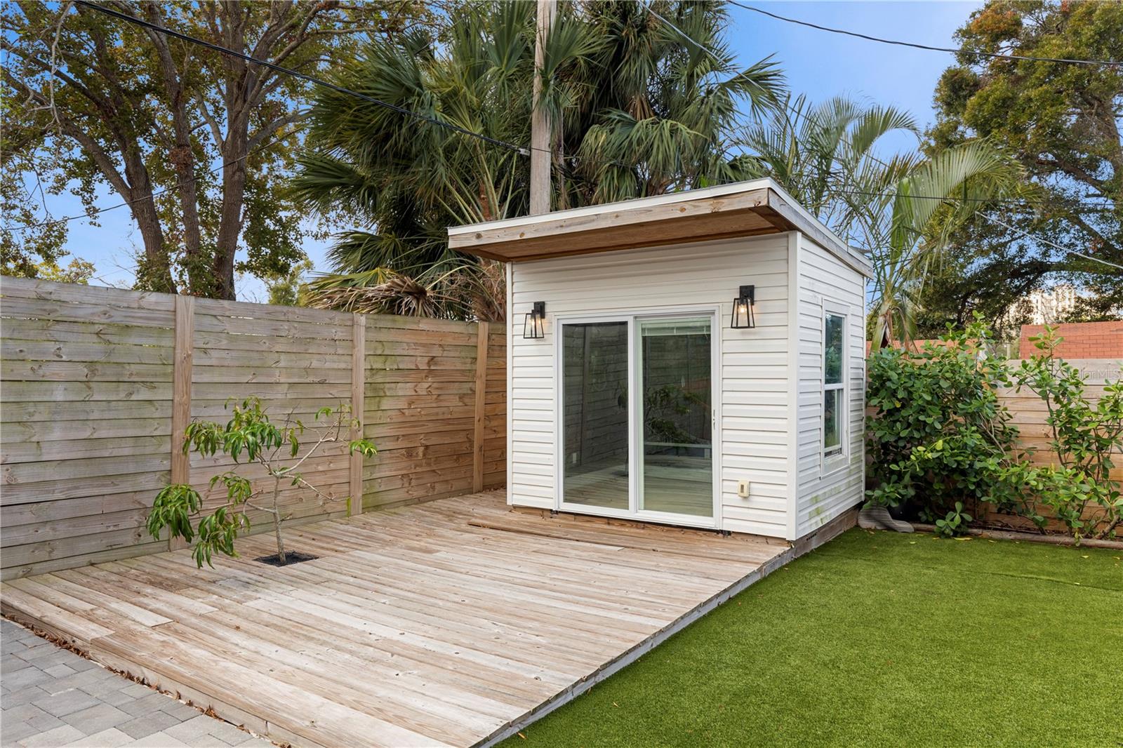 Explore endless possibilities with the climate-controlled she shed in the backyard—perfect as a home office, art studio, or private retreat, adding versatility and charm to this South Tampa property.