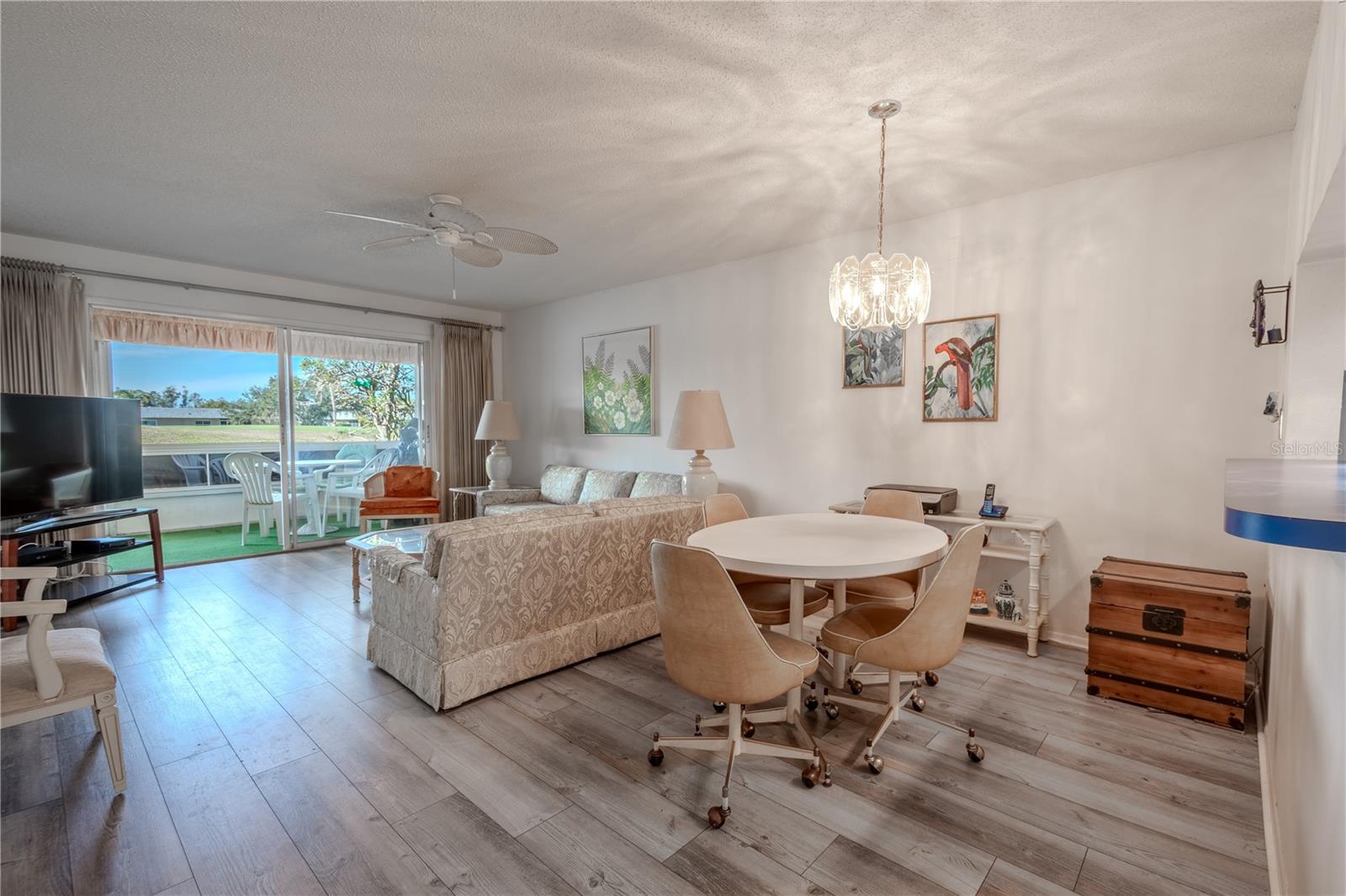 The dining room features a pendant light and is open to the living room.