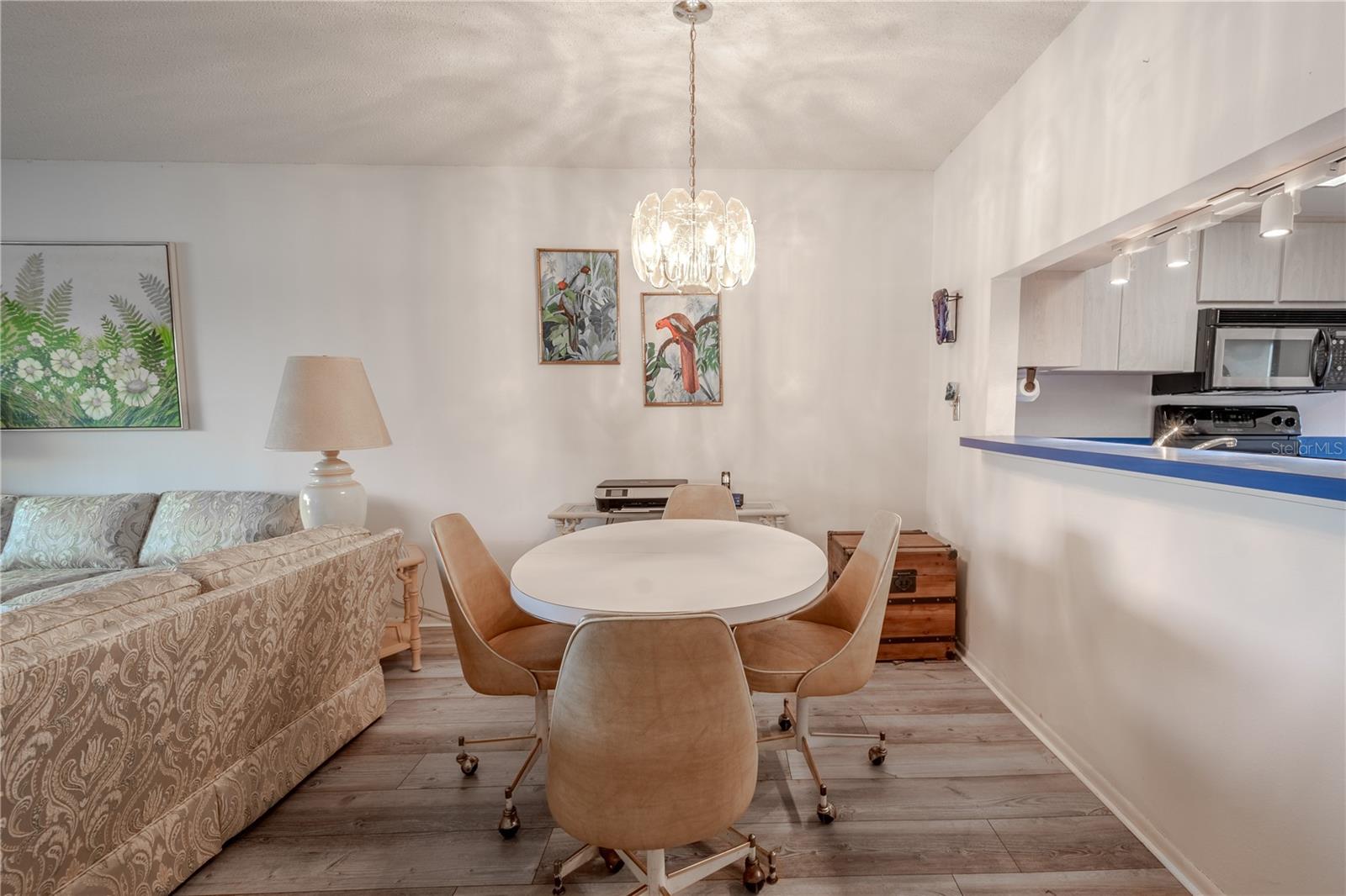 The dining room features a pendant light and is open to the living room and kitchen pass thru.