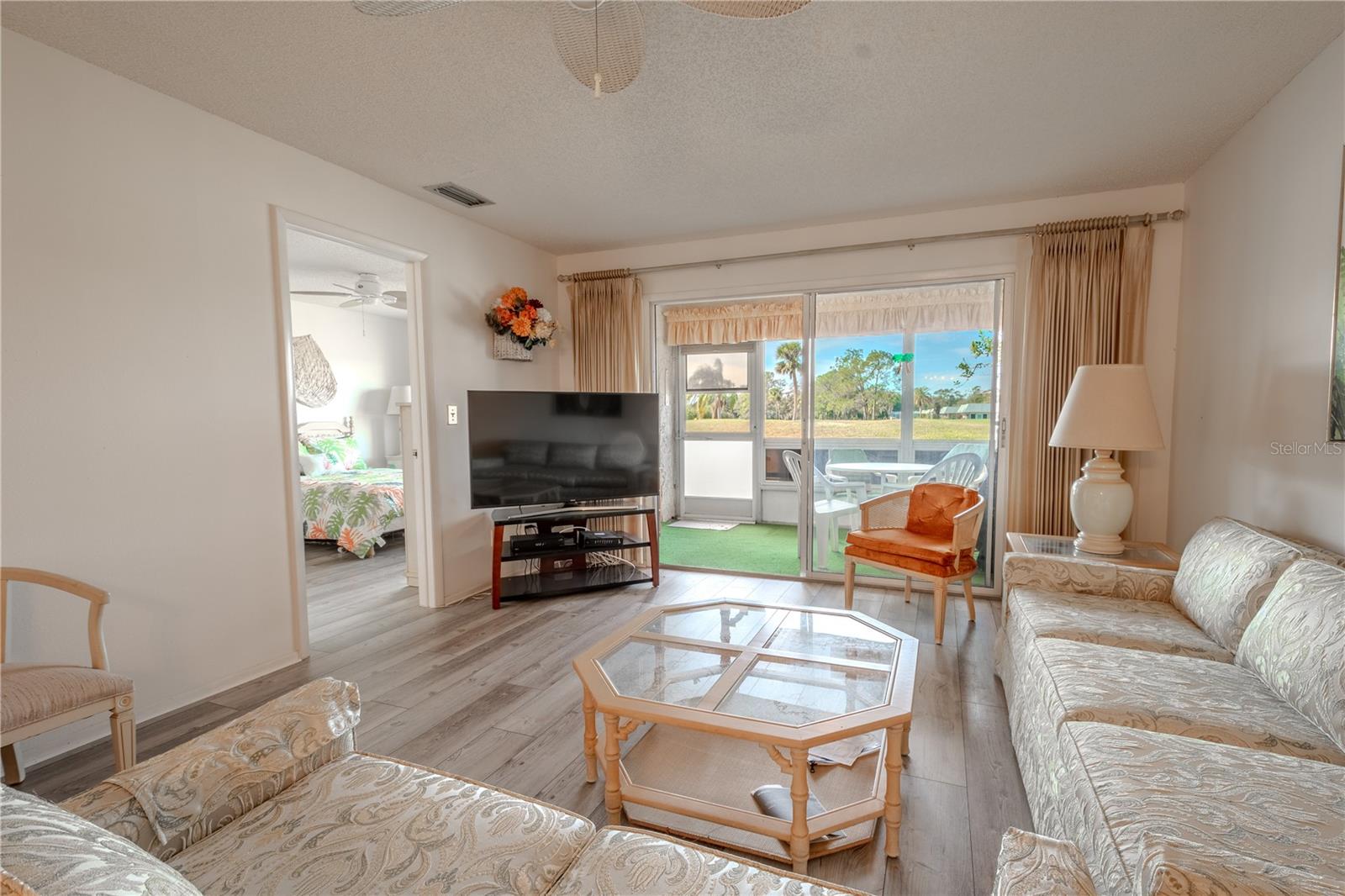 The primary bedroom is off the living room with a view of the golf course.