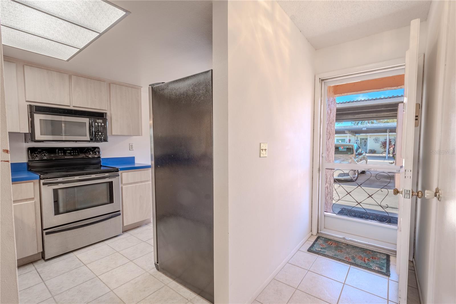 Enter into foyer with ceramic tile floor with coat closet for additional storage.