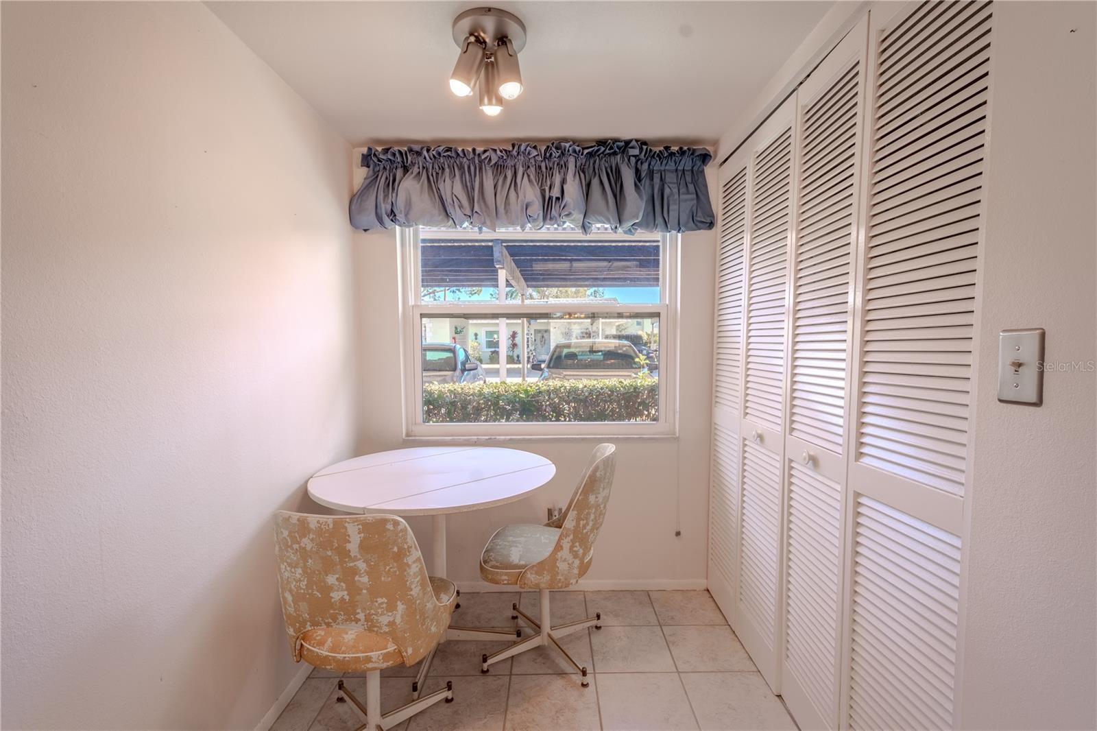 The kitchen has a quaint breakfast nook beneath a window.