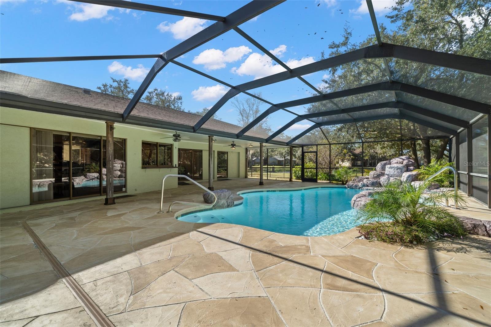 Pool with Waterfall - large screened outdoor space