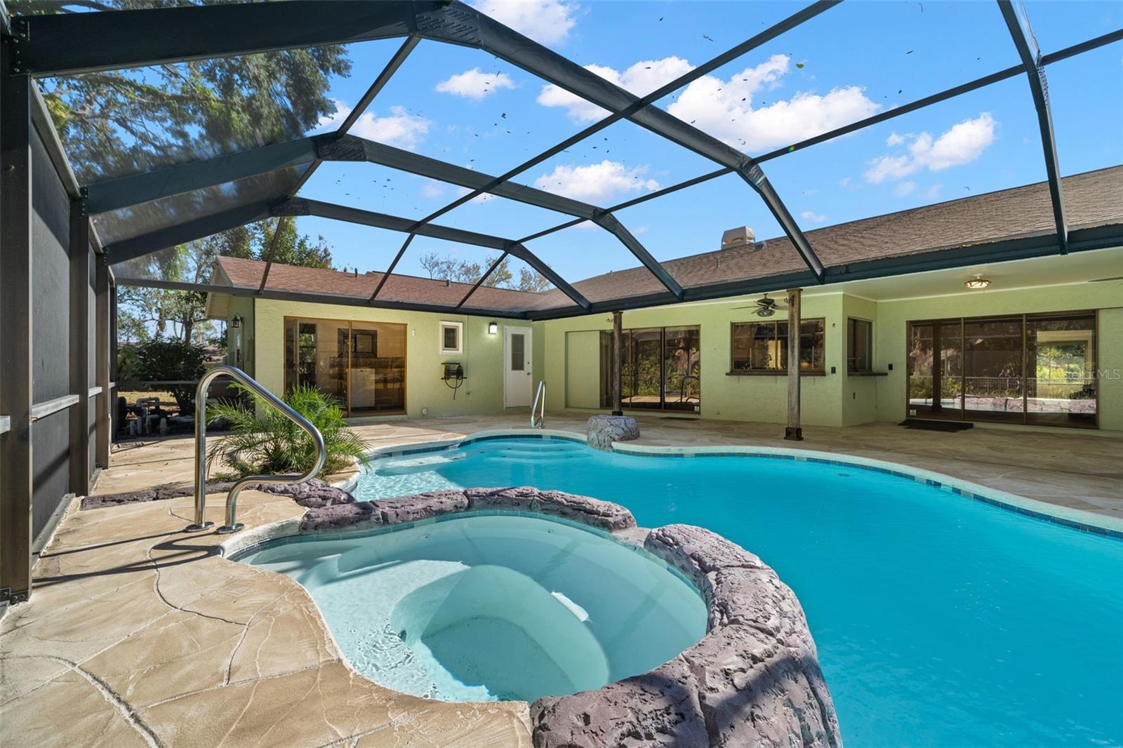 Pool with Waterfall - large screened outdoor space