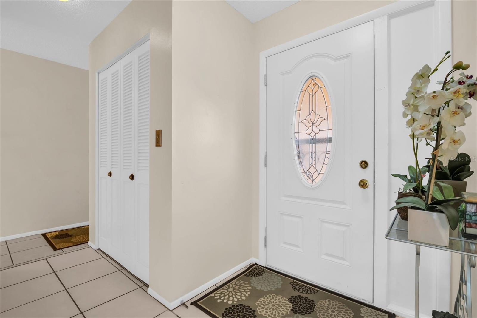 Newer lead glass front door & double closet at the foyer~