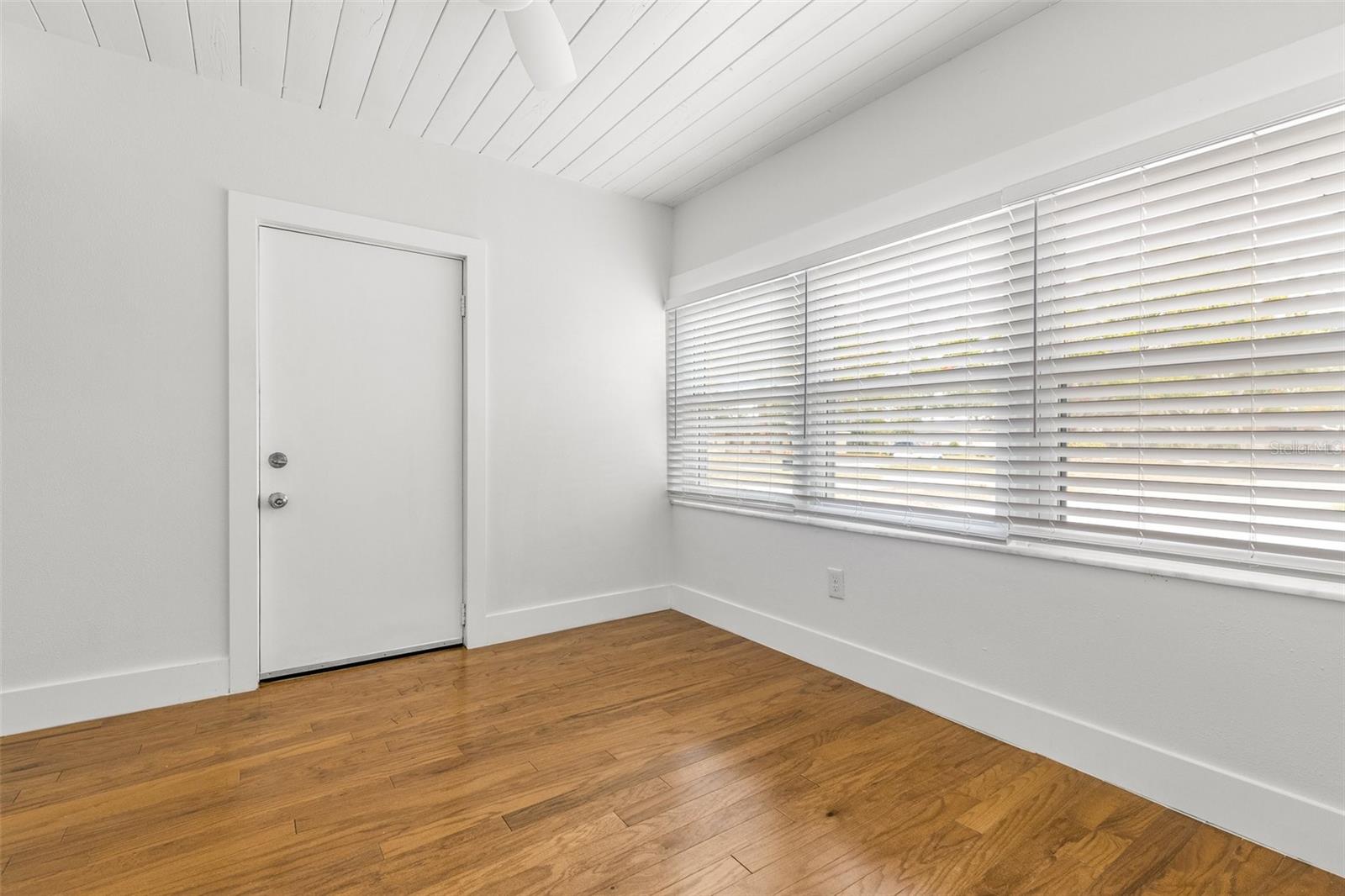 Bead board ceiling in office/den; door opens to garage