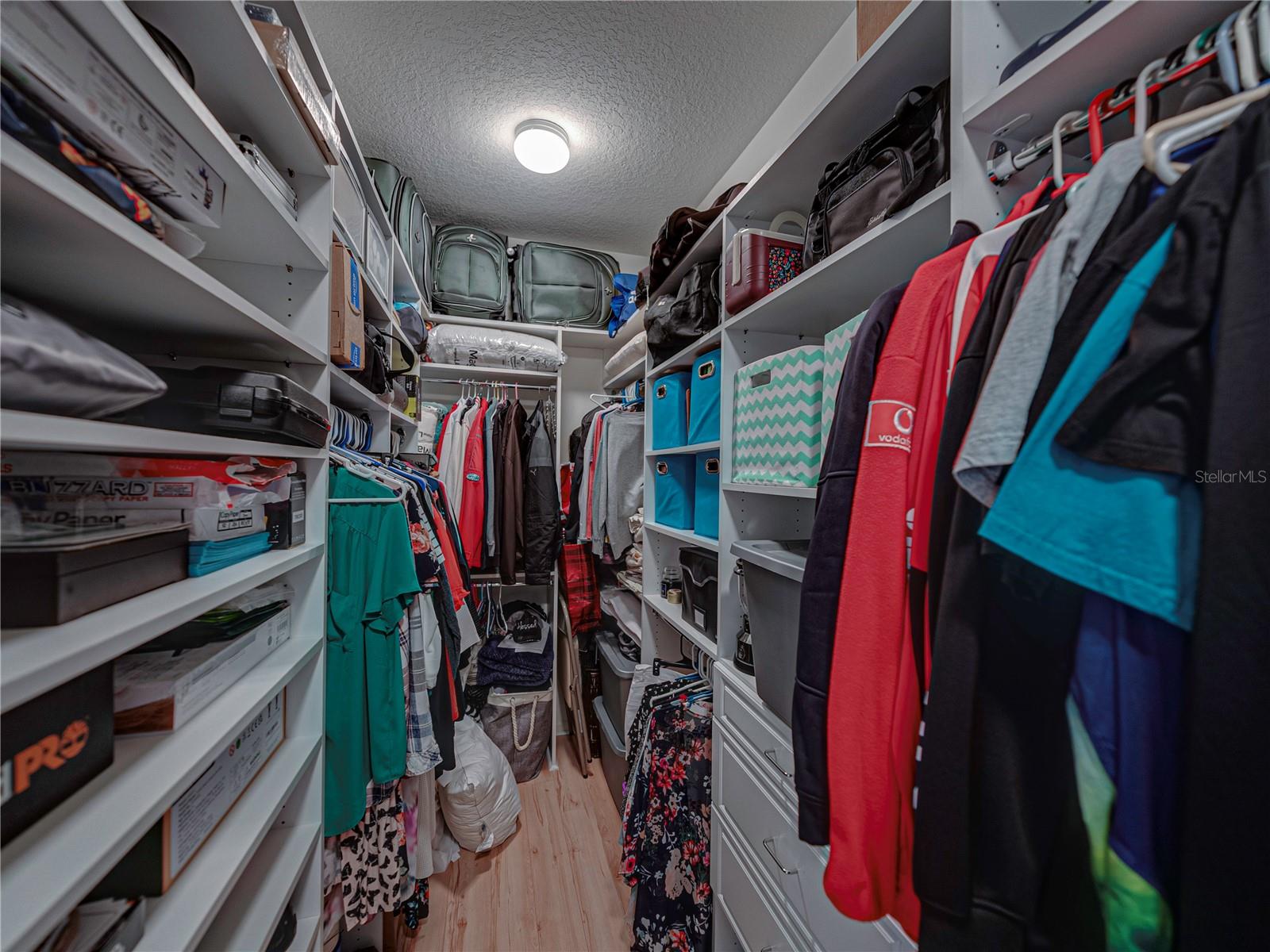 Walk in closet has built in shelving system