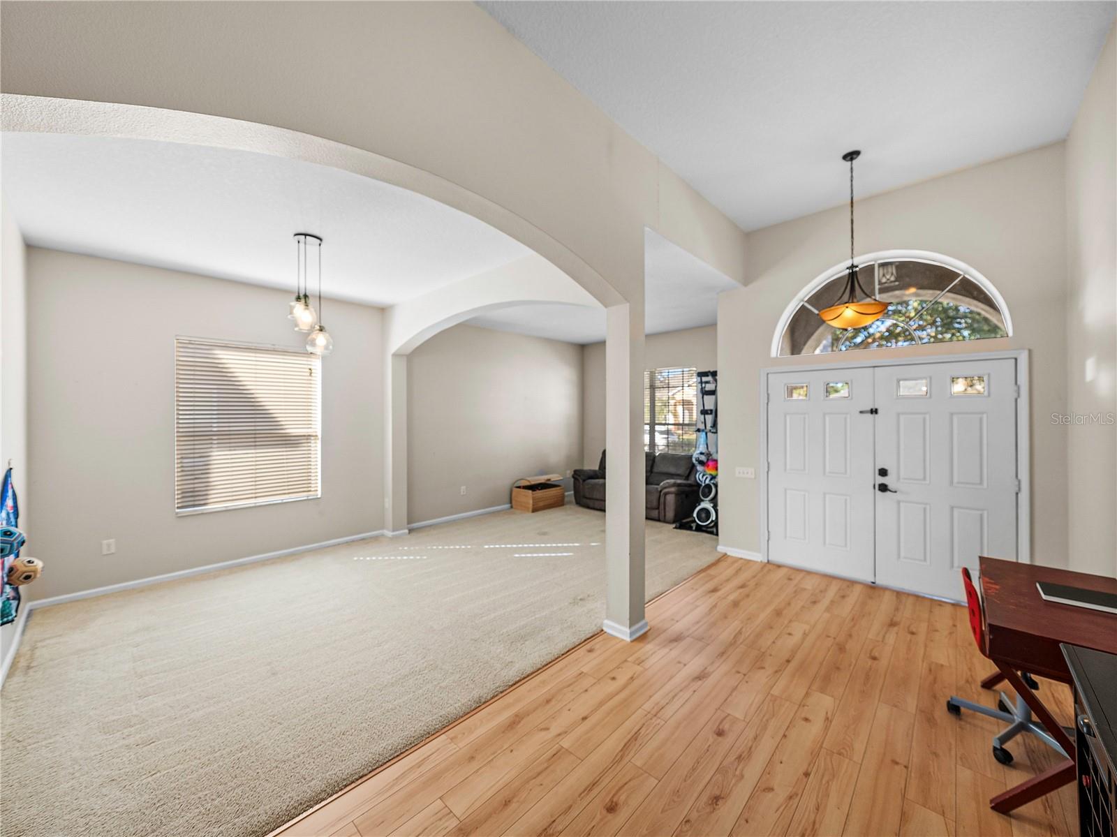 View of formal dining and living room and double entry doors