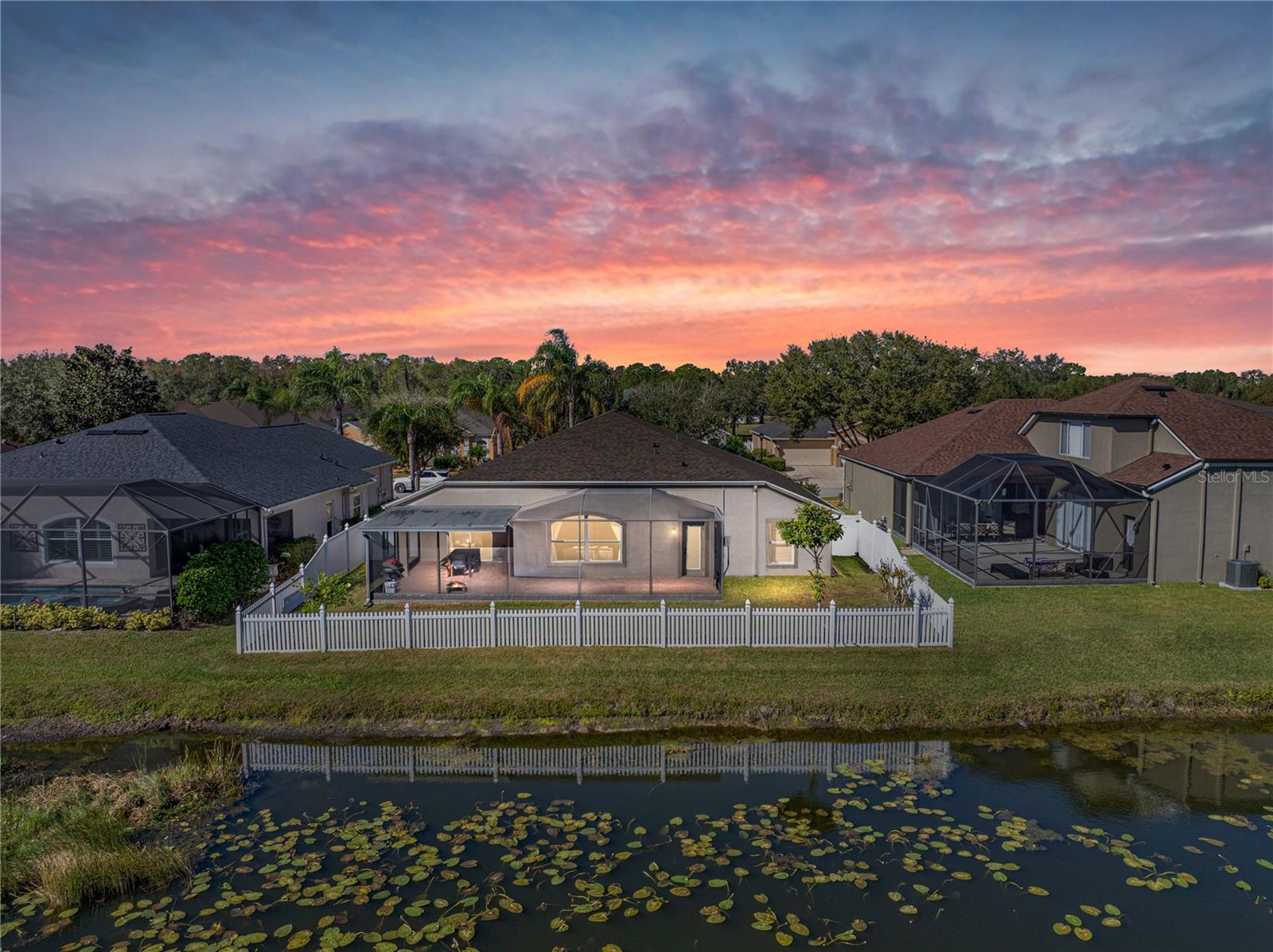 Night view of back of home taken from above the pond