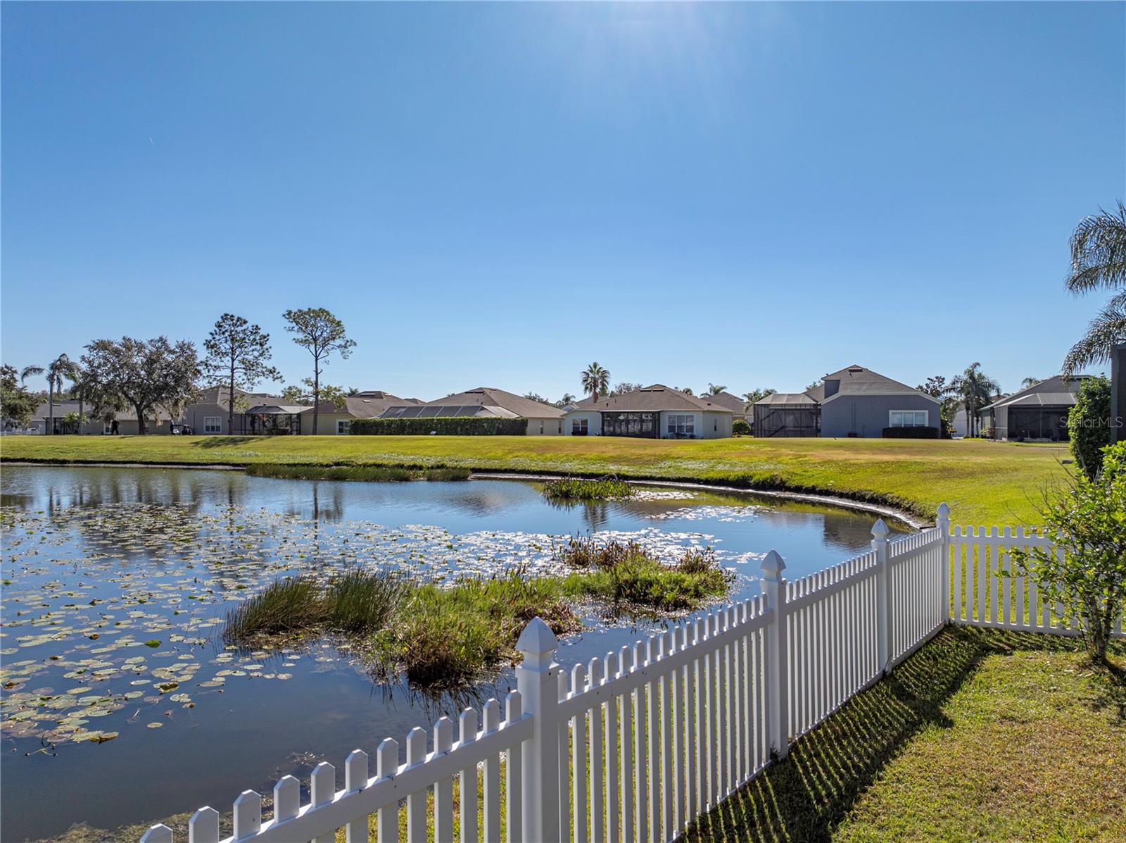 View of pond from the back yard and golf tee in distance