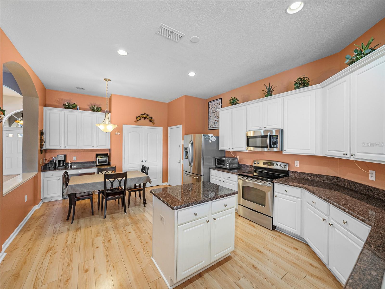 Kitchen features an island and dinette area