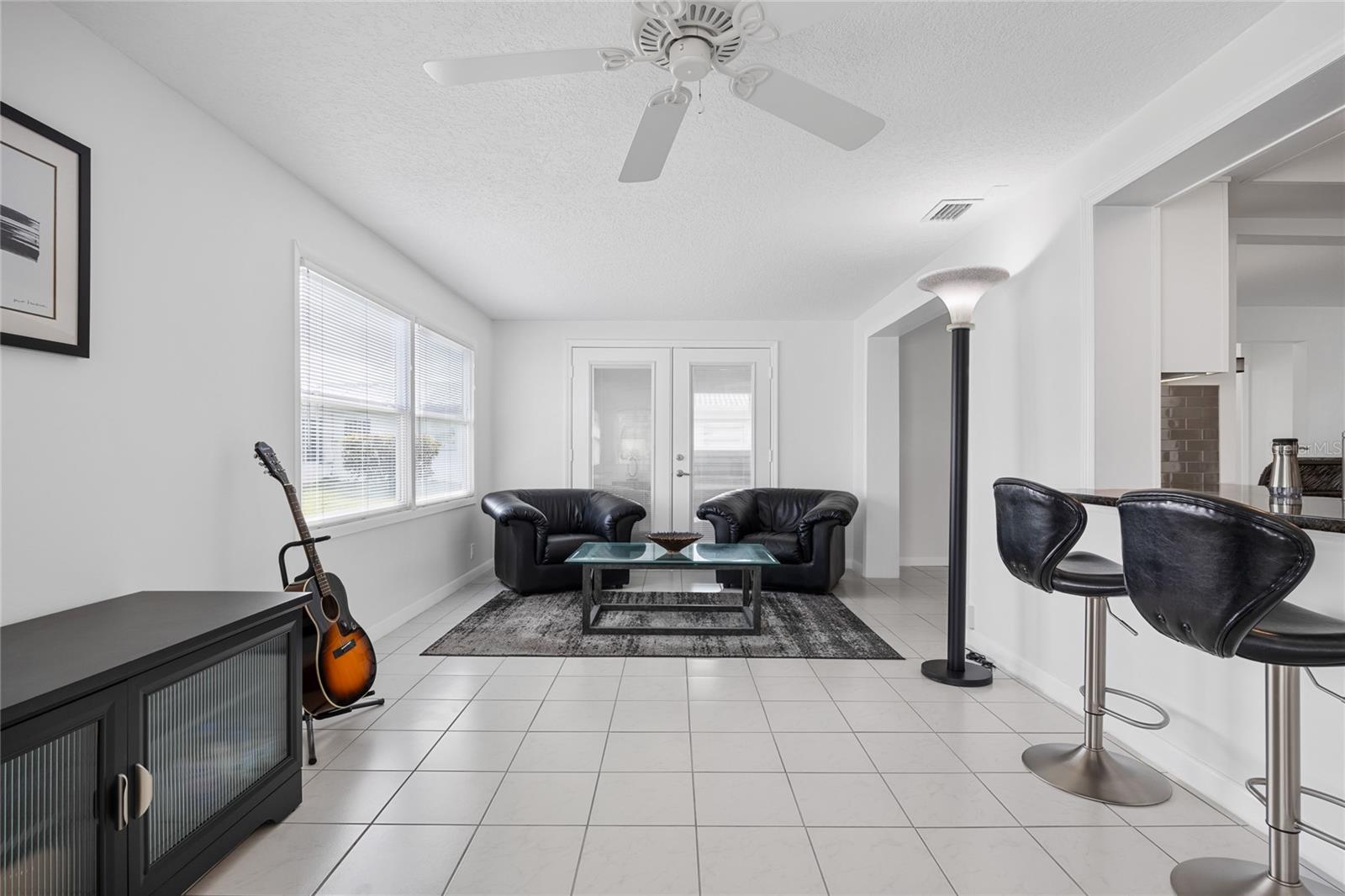 Additional view of the Family Room that has so many different possible uses!   The current owner uses it as a workout and hobby space with an additional conversation area.