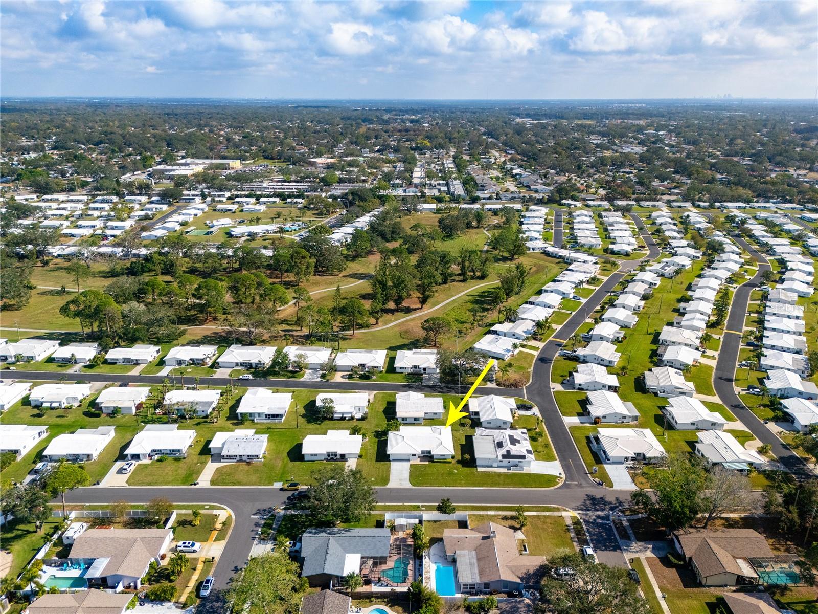 This aerial view looks East and shows the greenspace and walking trails.