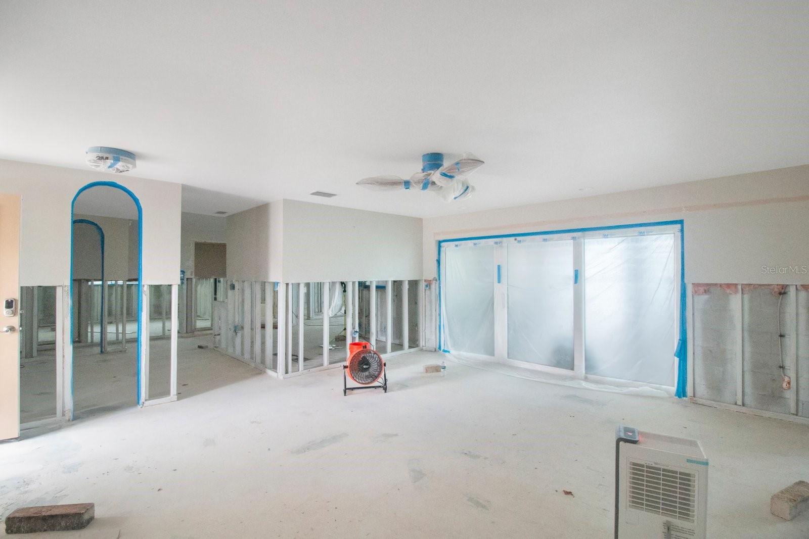 Large living room with slider doors to the covered private pool.