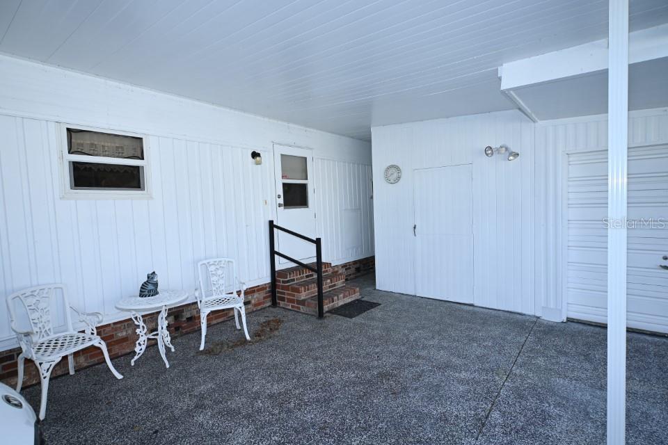 Kitchen entry, workshop & golf cart garage under carport