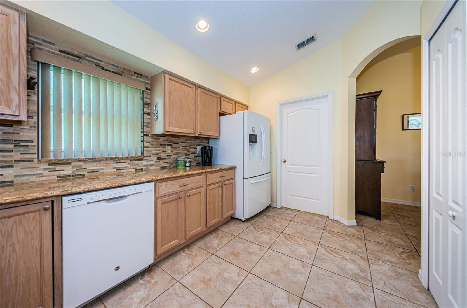 Kitchen with granite counter and wood cabinets