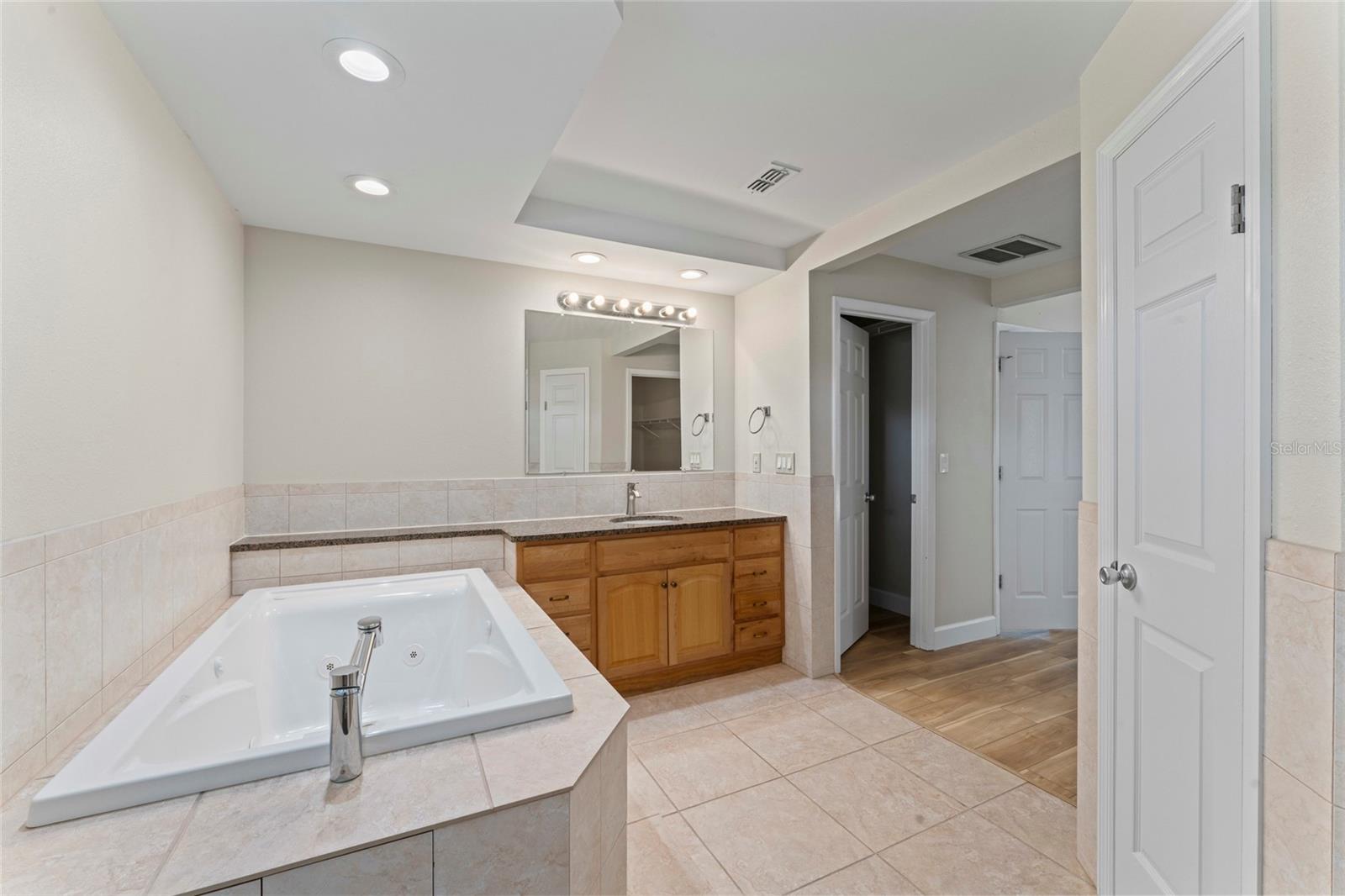 features deep, jetted soaking tub..