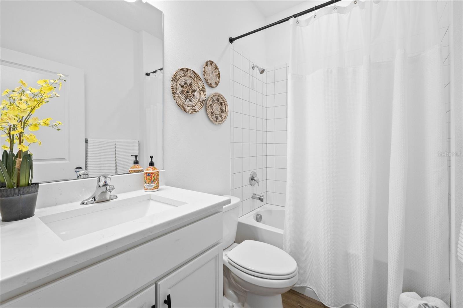 Bathroom 2 with full shower/tub & quartz countertops.