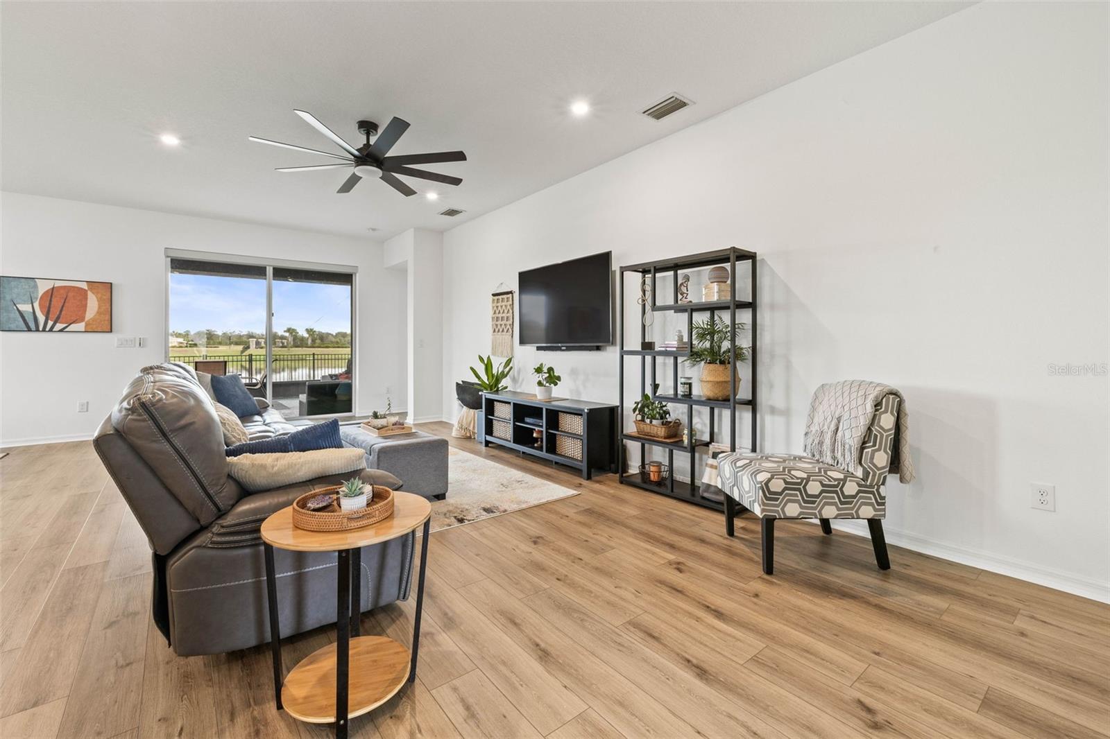 The living room is perfect for a large sectional or couch & chairs set with overhead fan and lighting.