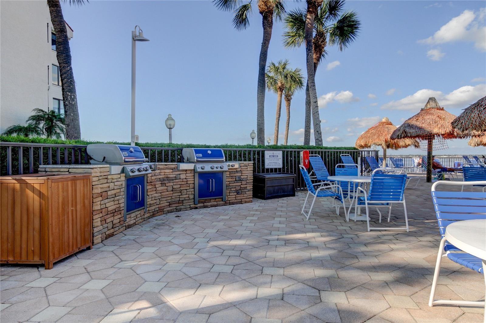 Gas grills in pavered area of pool with plenty of seating.  Enjoy outdoor dining with sunset views!