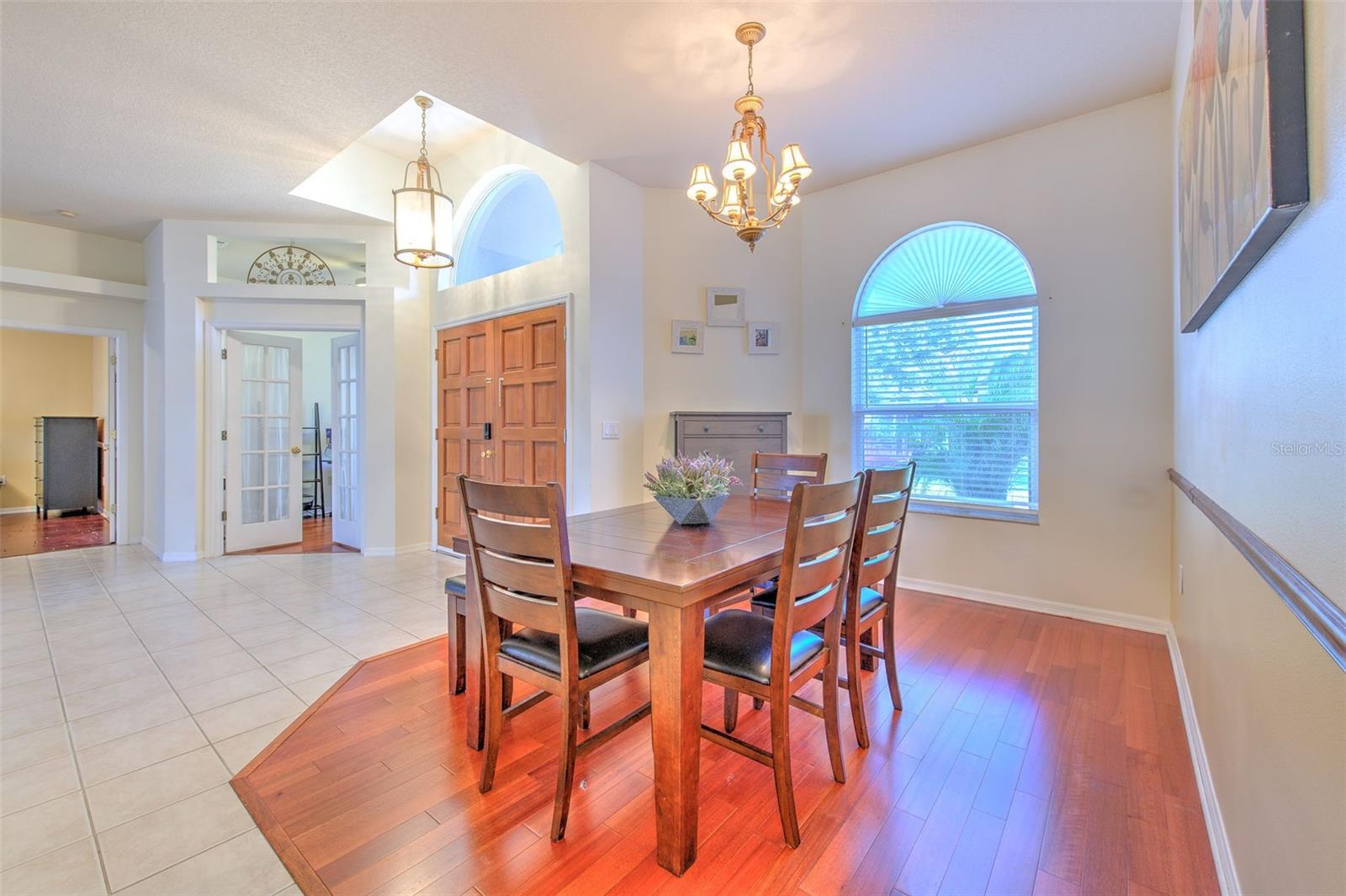 Dining Room is near office, primary suite, and open to the Living Room