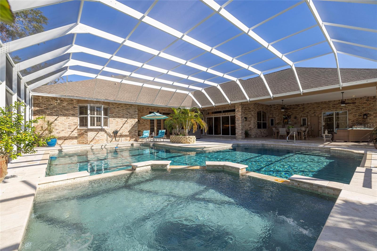 Massive resort style gas heated spillover spa & pool.  Fabulous outside summer kitchen perfect for entertaining!