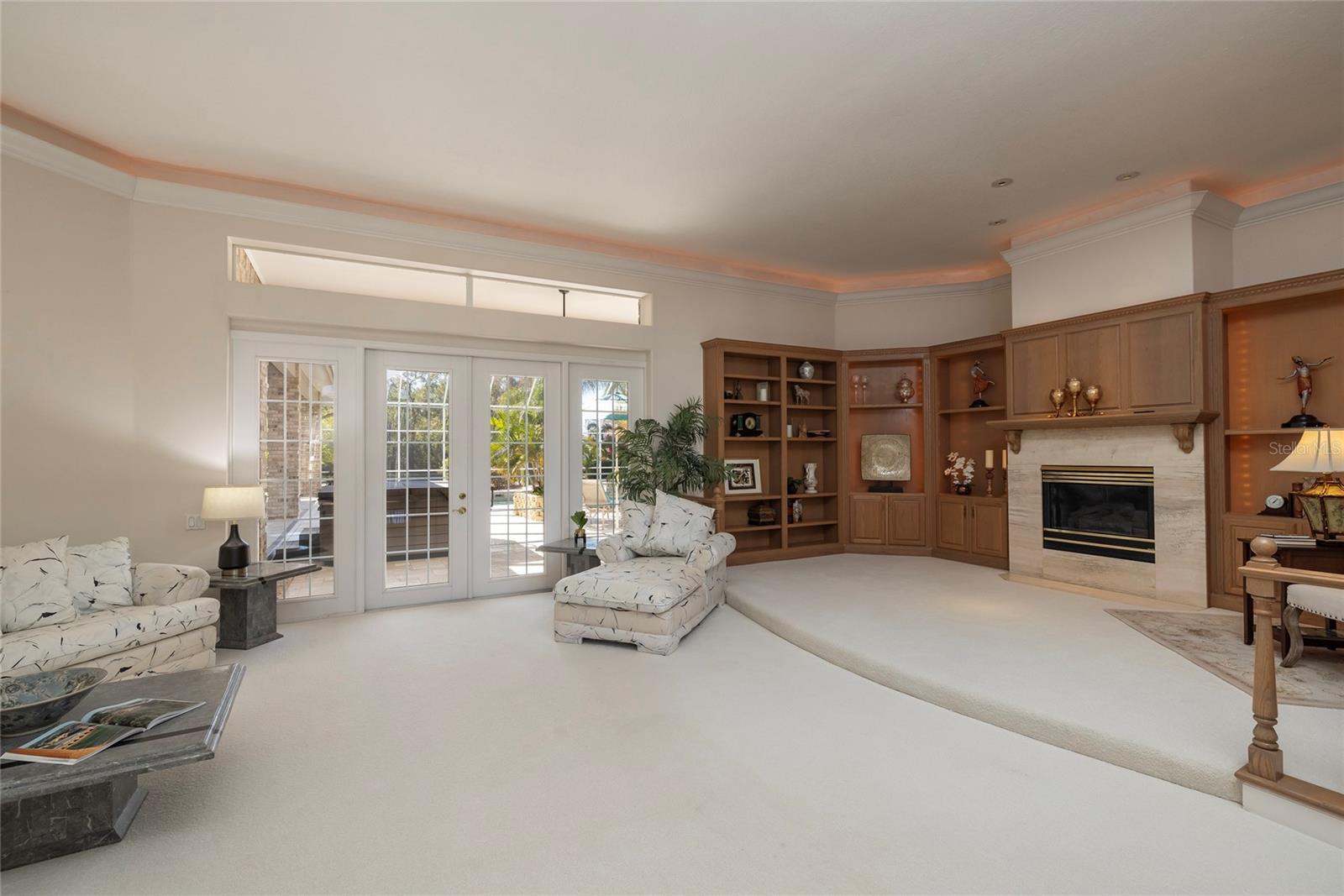 Spacious living room with custom wood cabinetry and gas fireplace