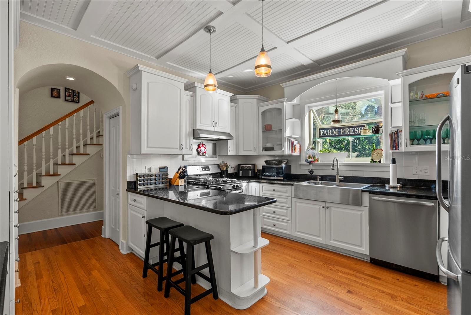 Curved archways are some of the beautiful historic craftsmanship this home provides